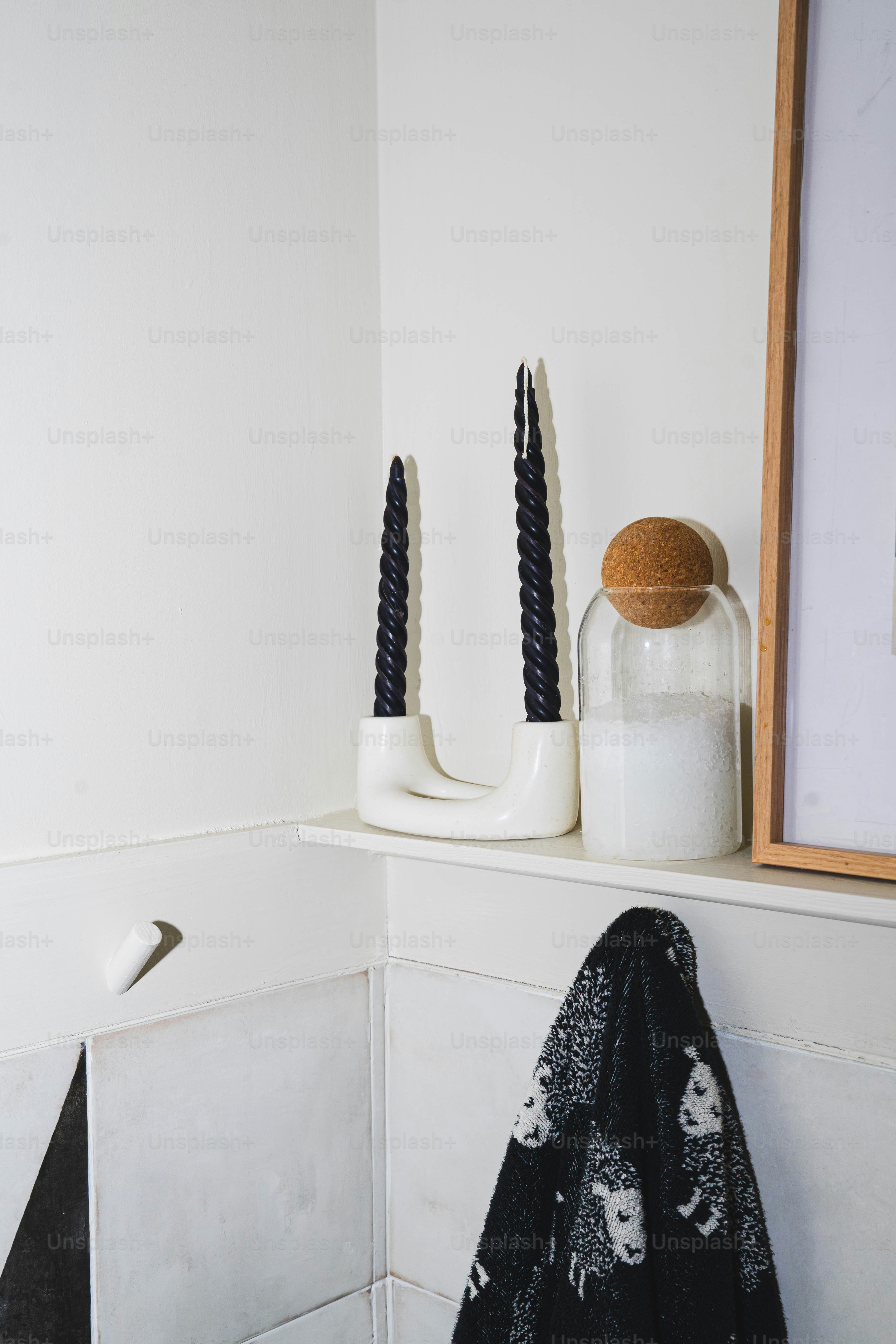 A bathroom with a mirror and a towel on a shelf