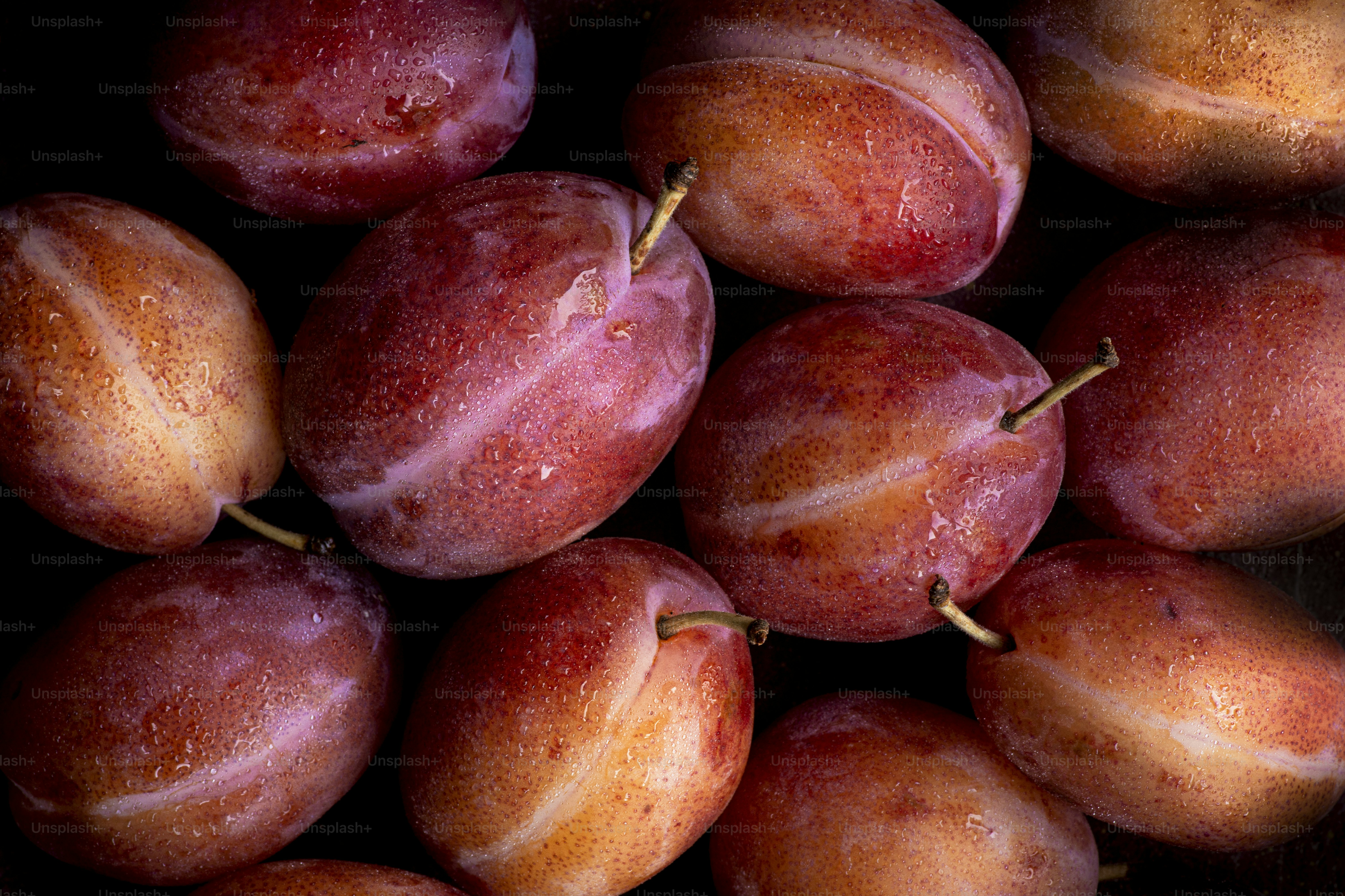 A pile of plums sitting on top of a table
