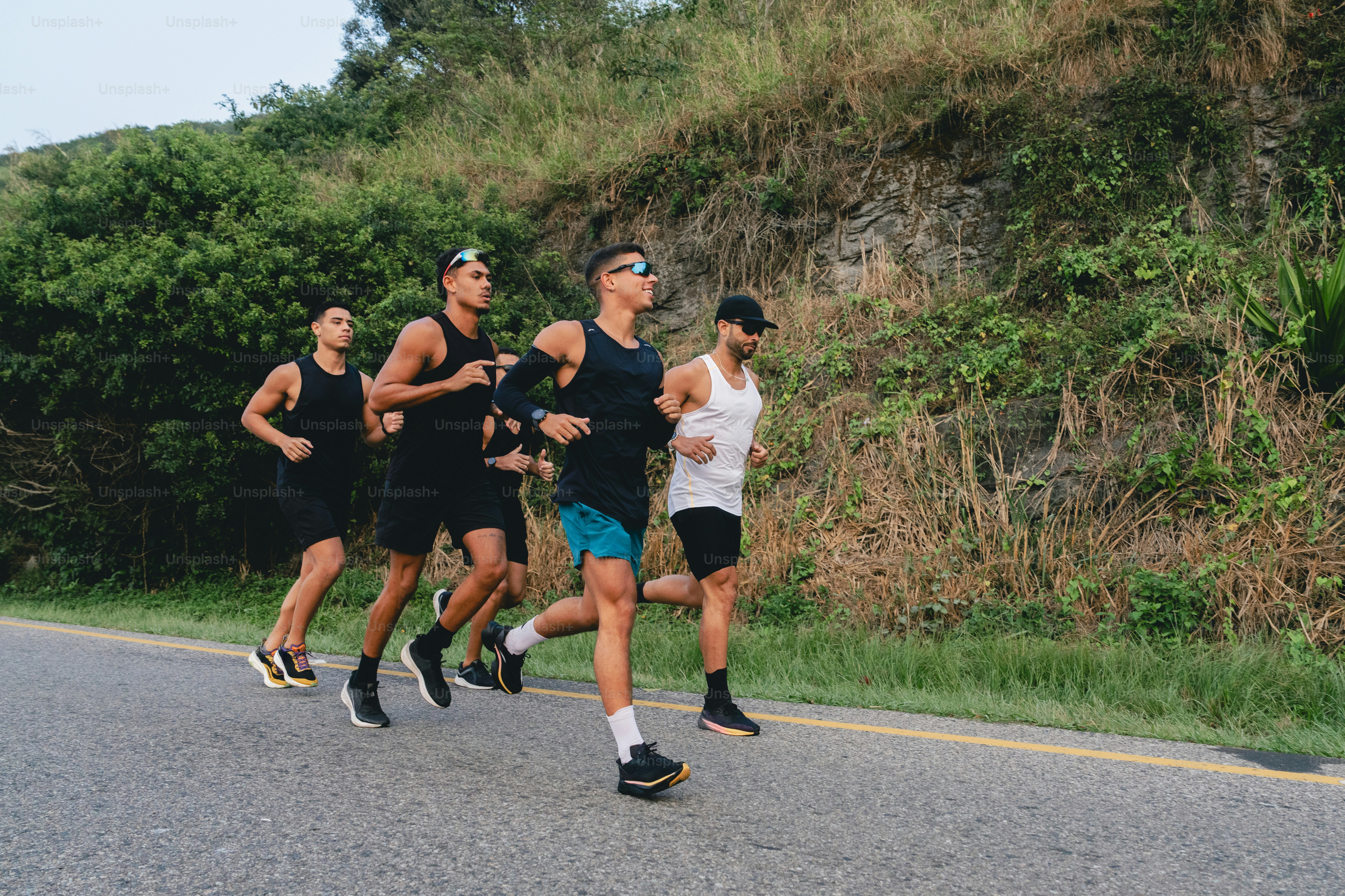 A group of people running down a street photo – Fitness Image on Unsplash