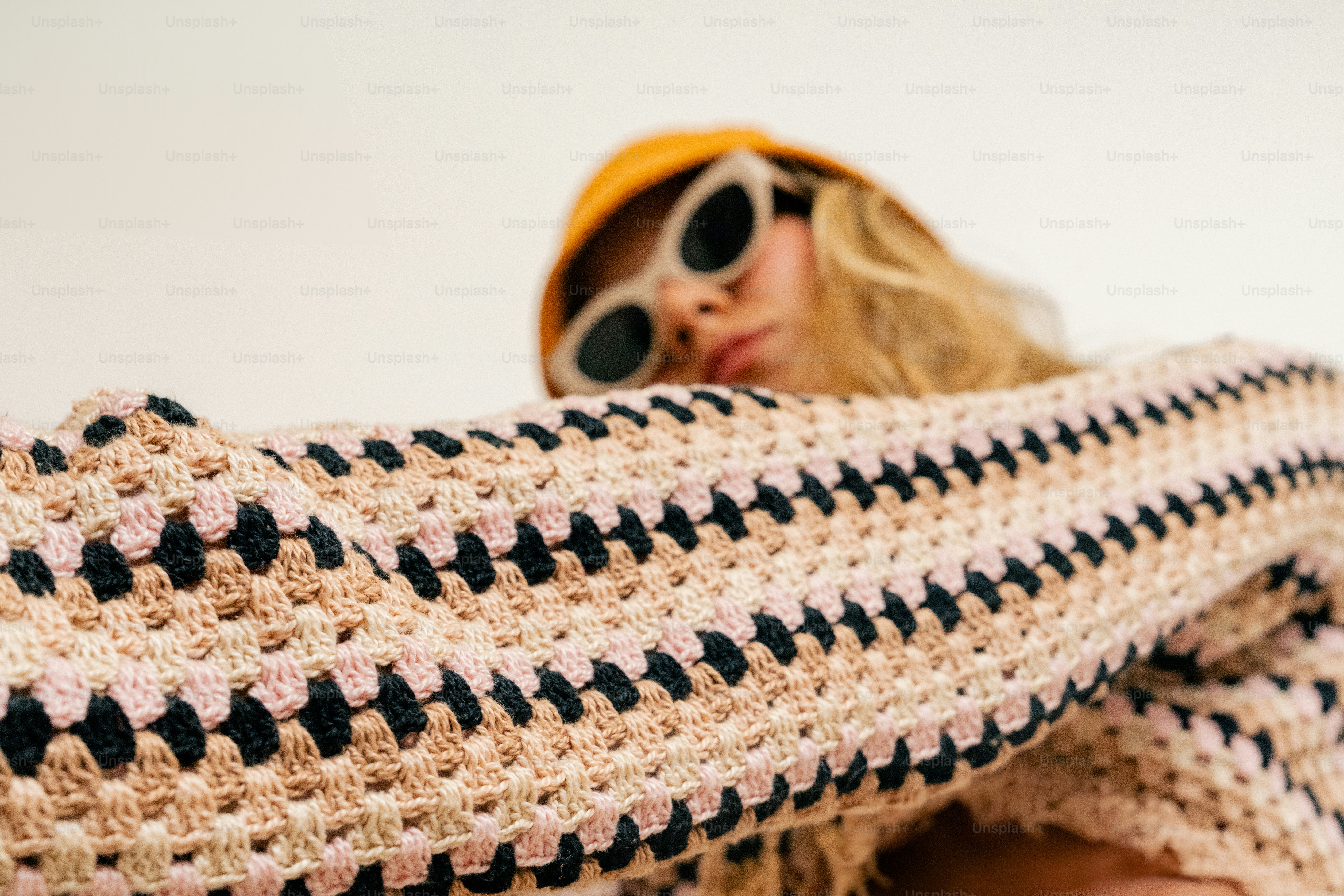 A woman wearing sunglasses and a knitted sweater