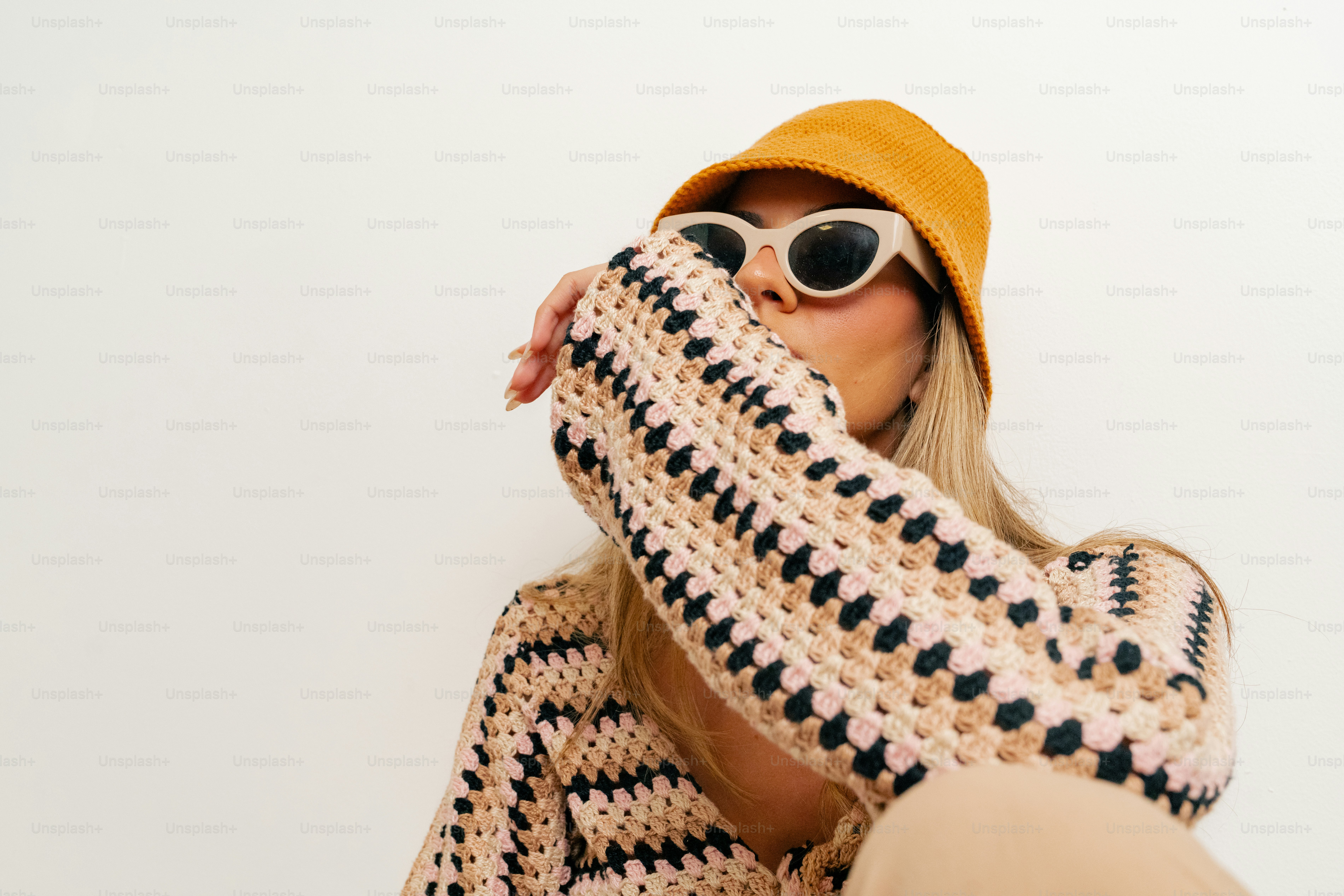 A woman wearing sunglasses and a knitted sweater