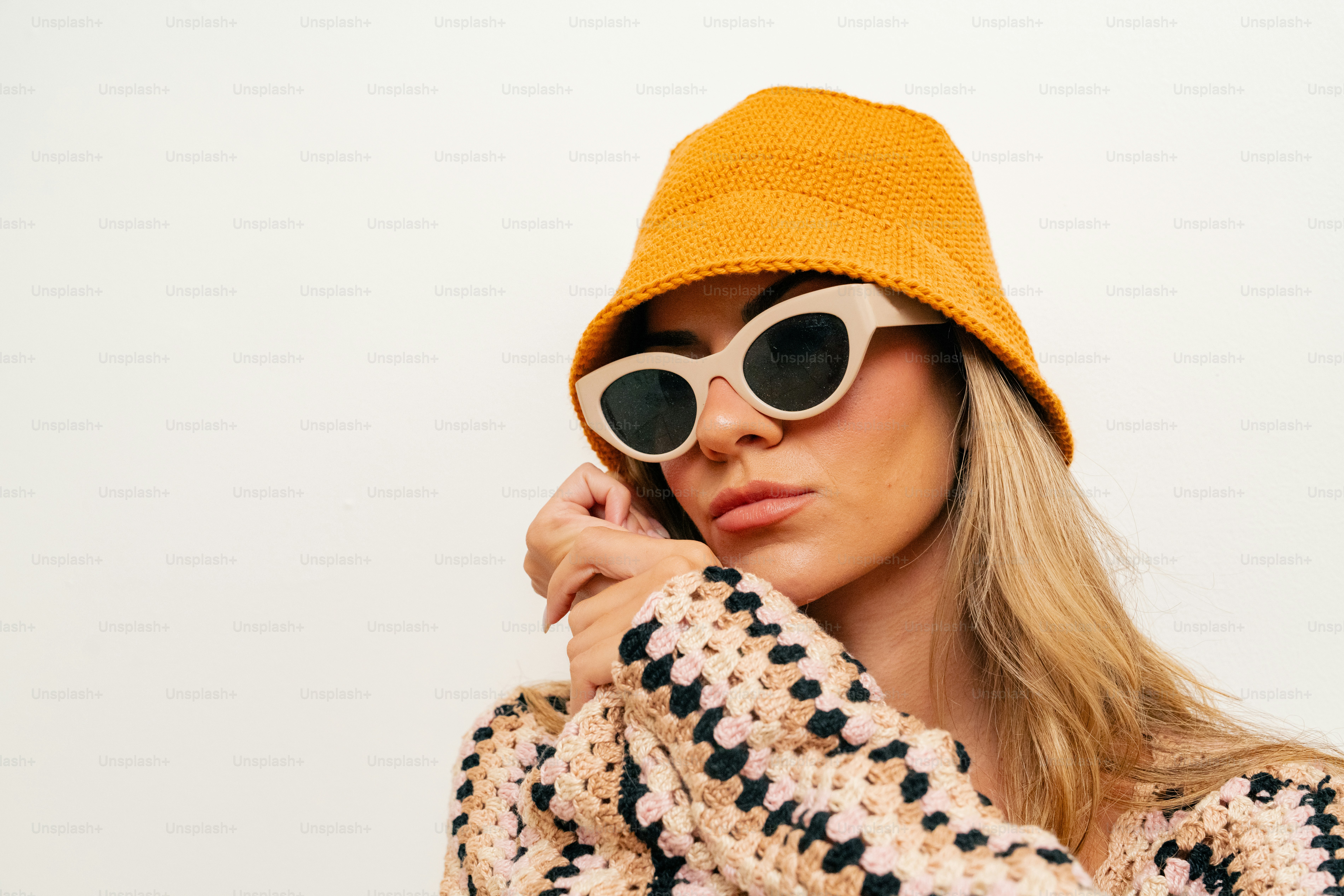 A woman wearing a yellow hat and sunglasses
