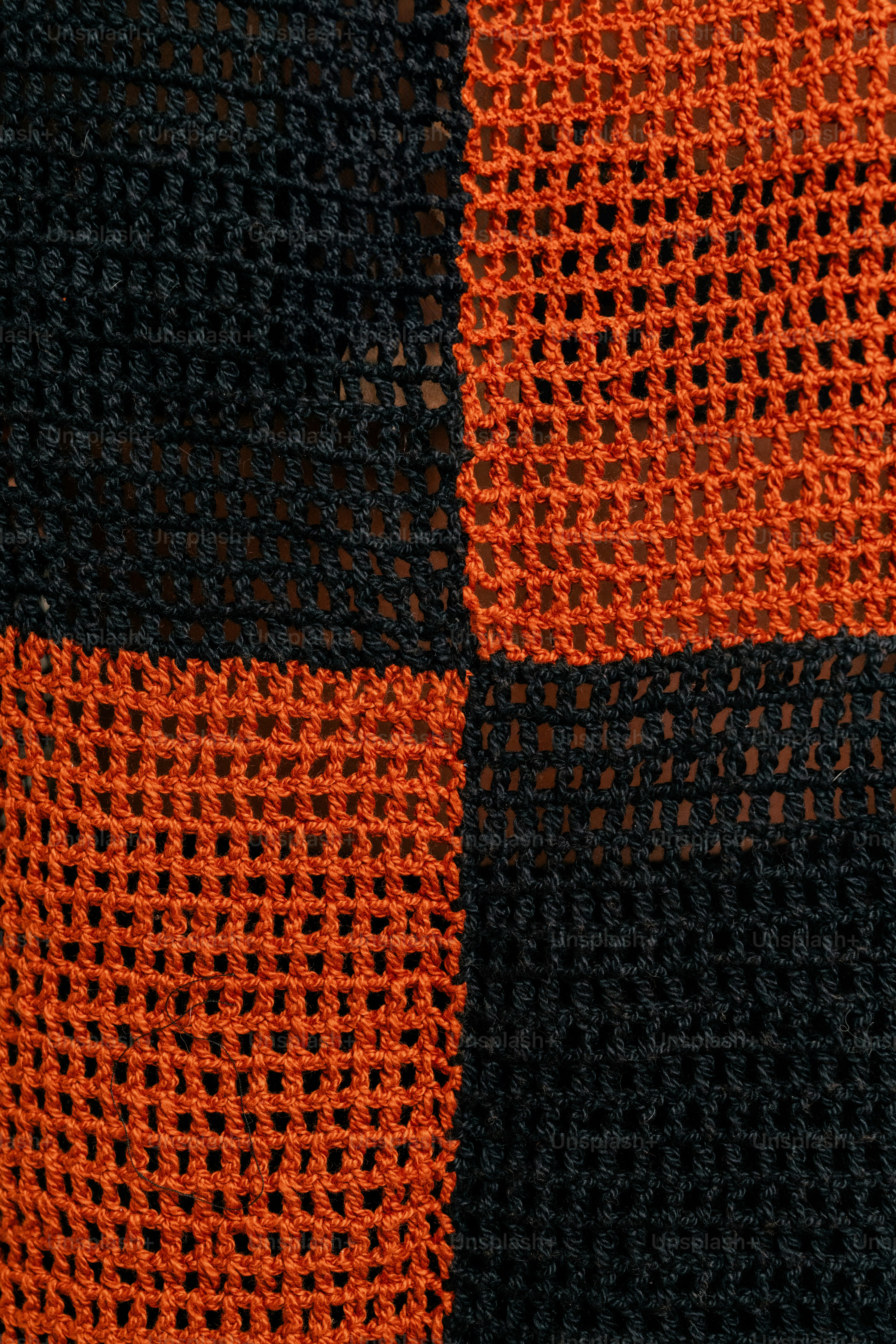 A close up of a black and orange blanket