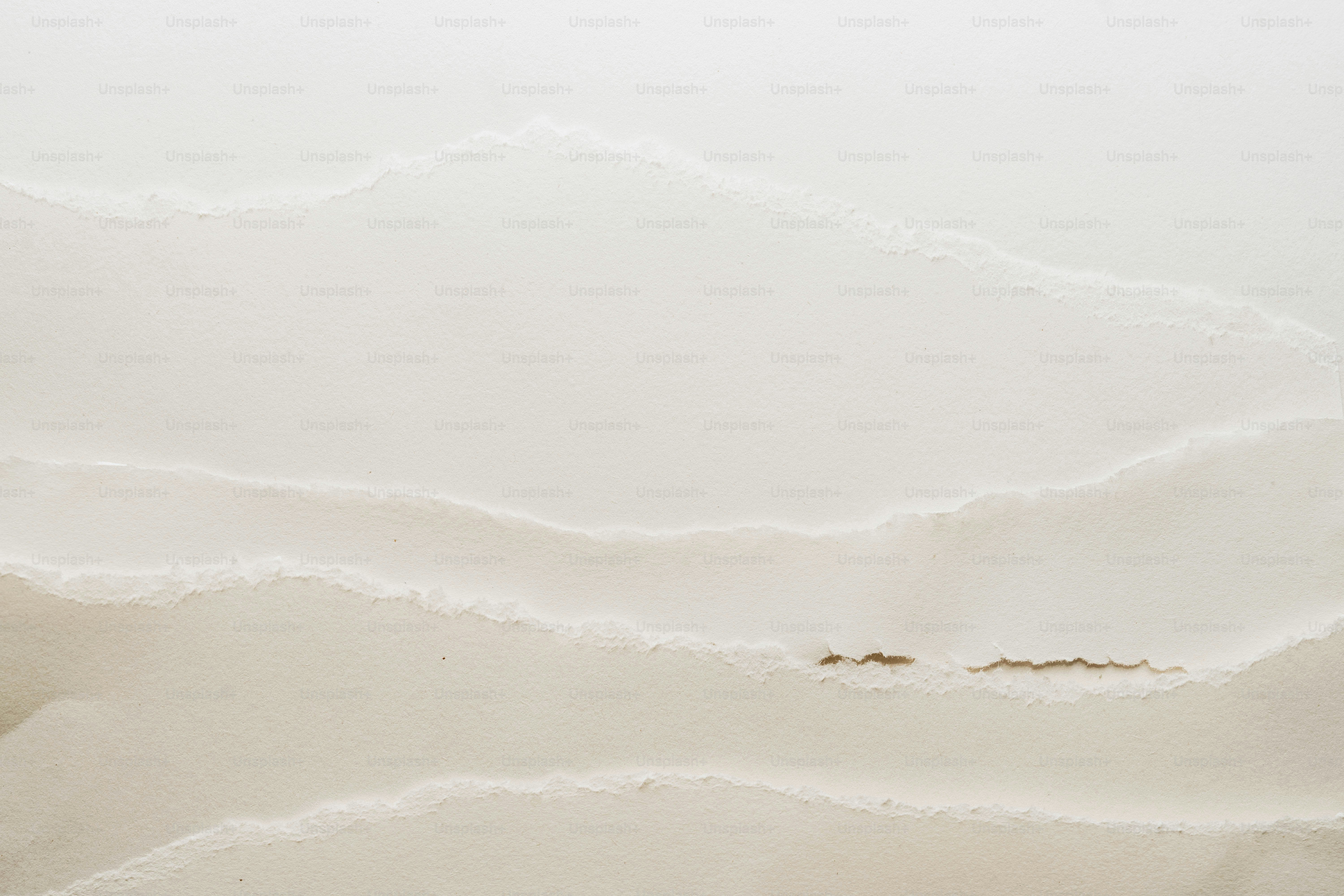 A close up of a bed with a white comforter