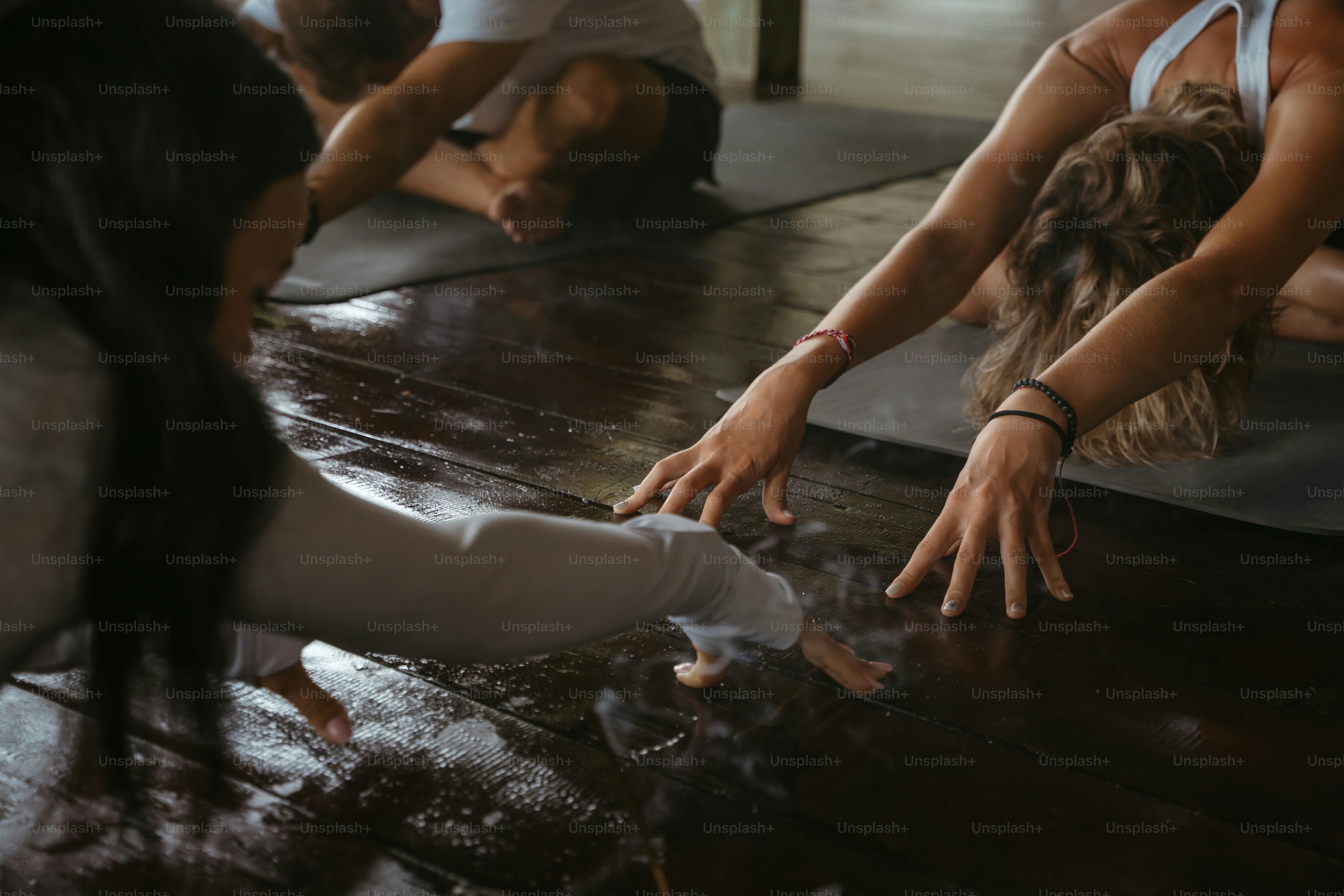 A group of people doing yoga in a room