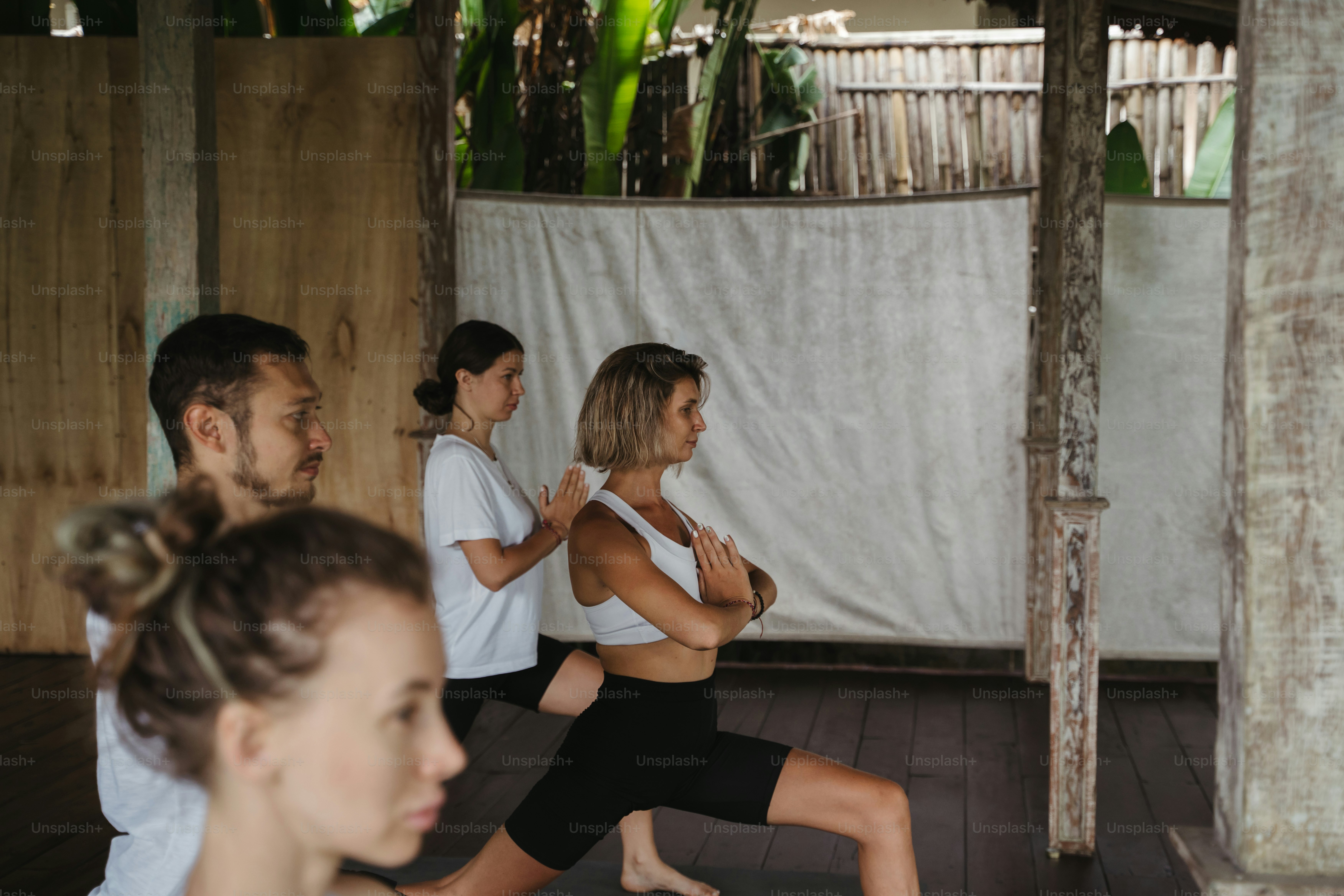 A group of people doing yoga in a room