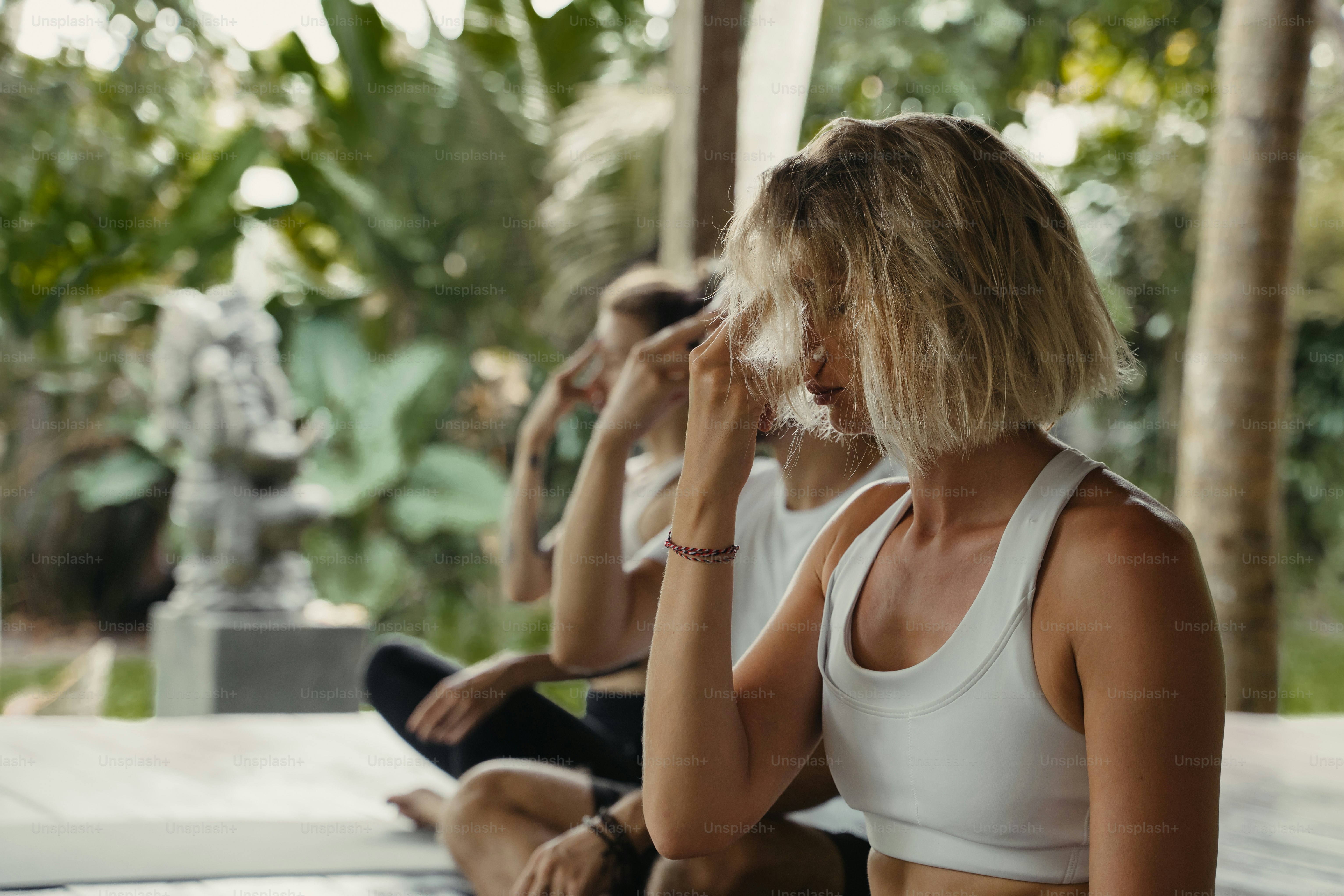 A group of women sitting on a bench next to each other