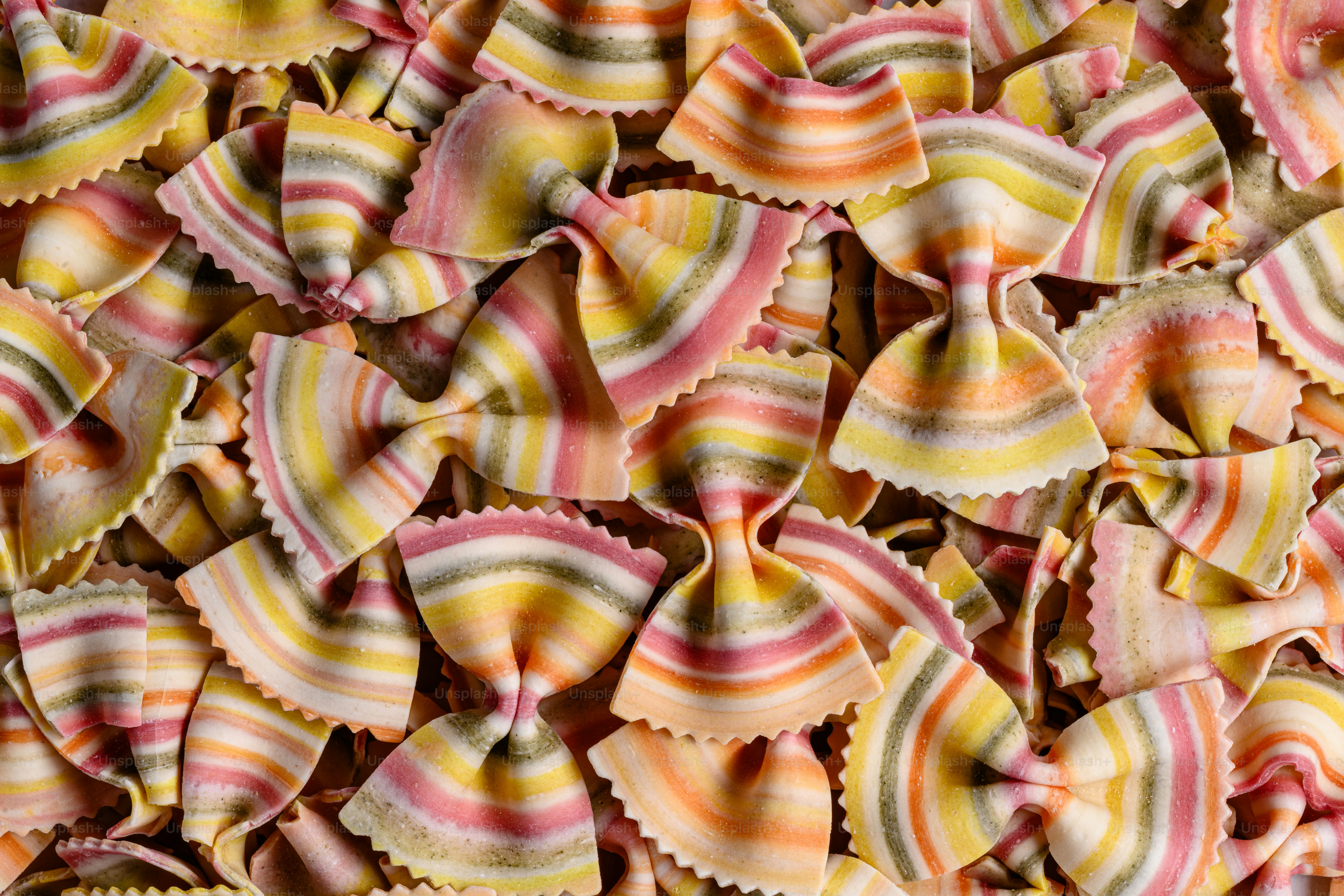 A pile of colorful pasta shells sitting on top of a table