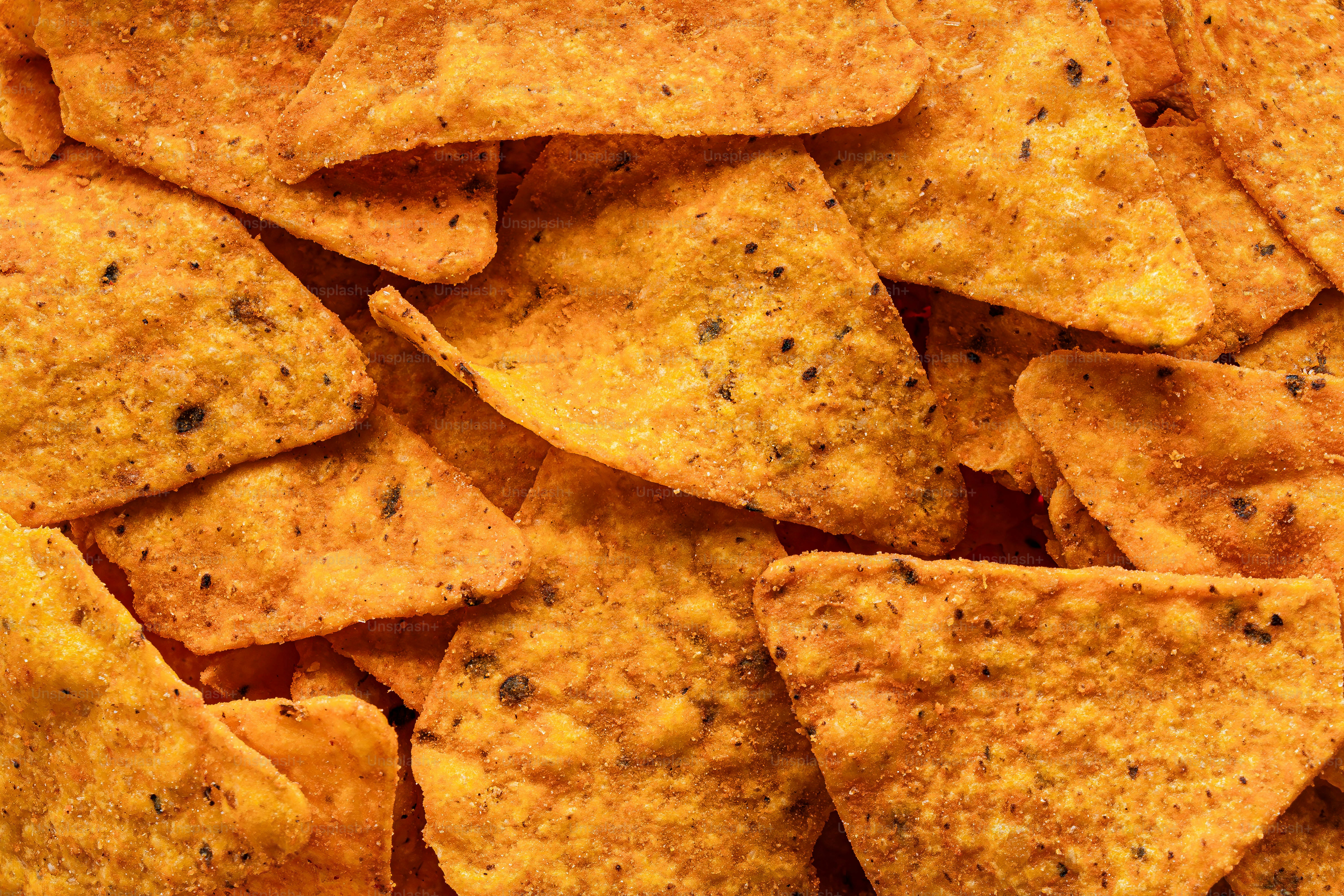 A pile of tortilla chips sitting on top of a table
