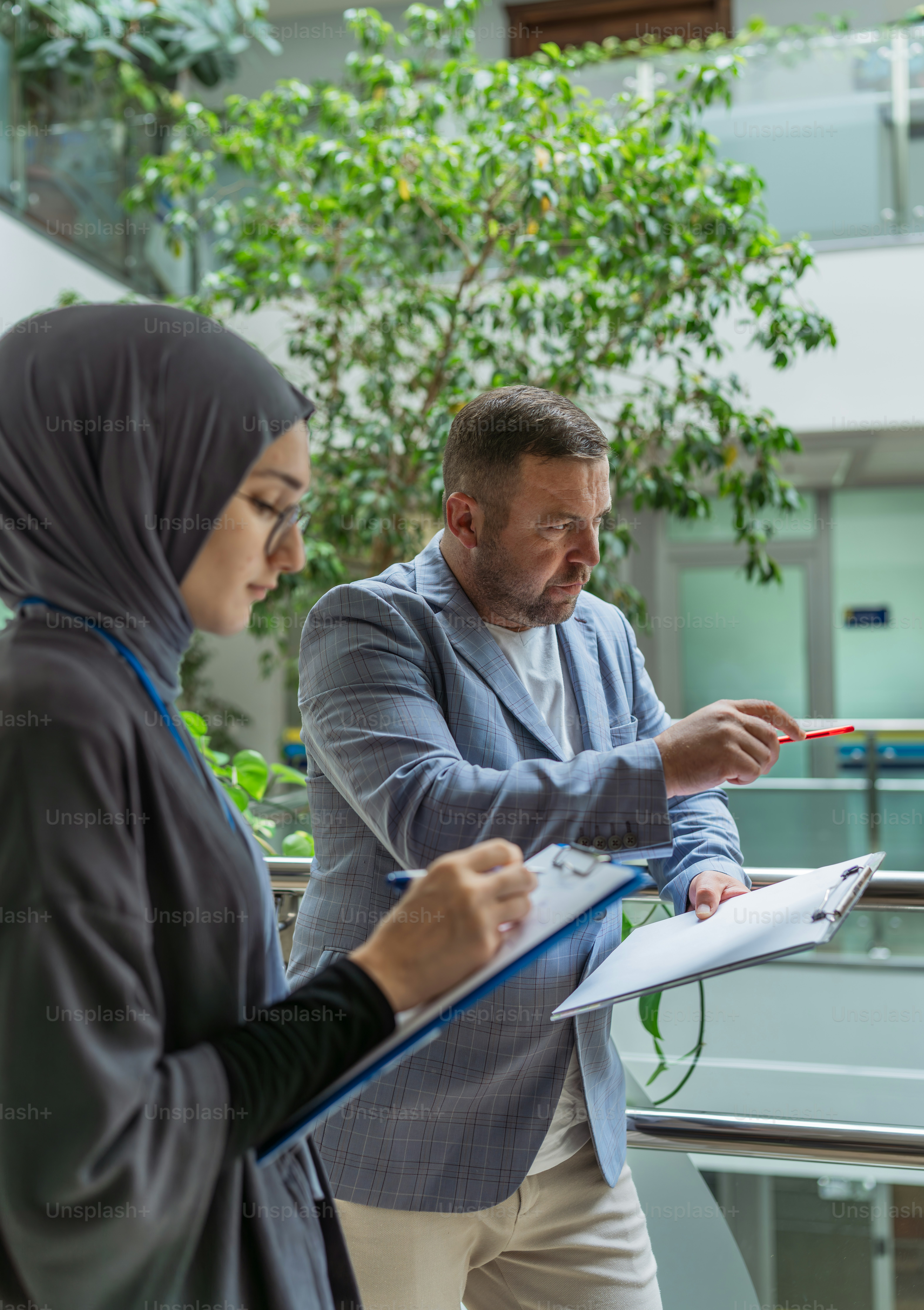 A couple of people standing around a table