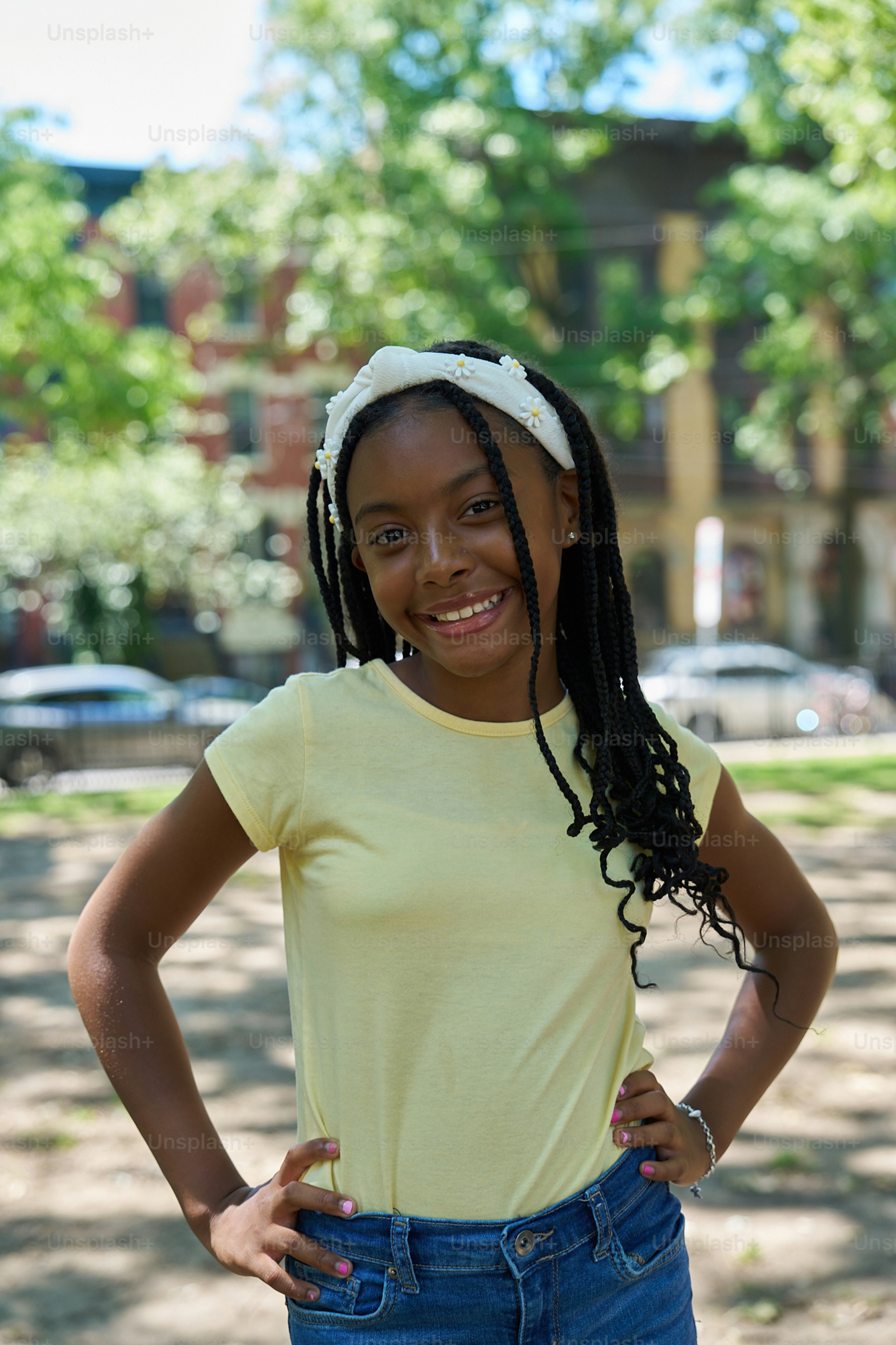 A young girl standing with her hands on her hips