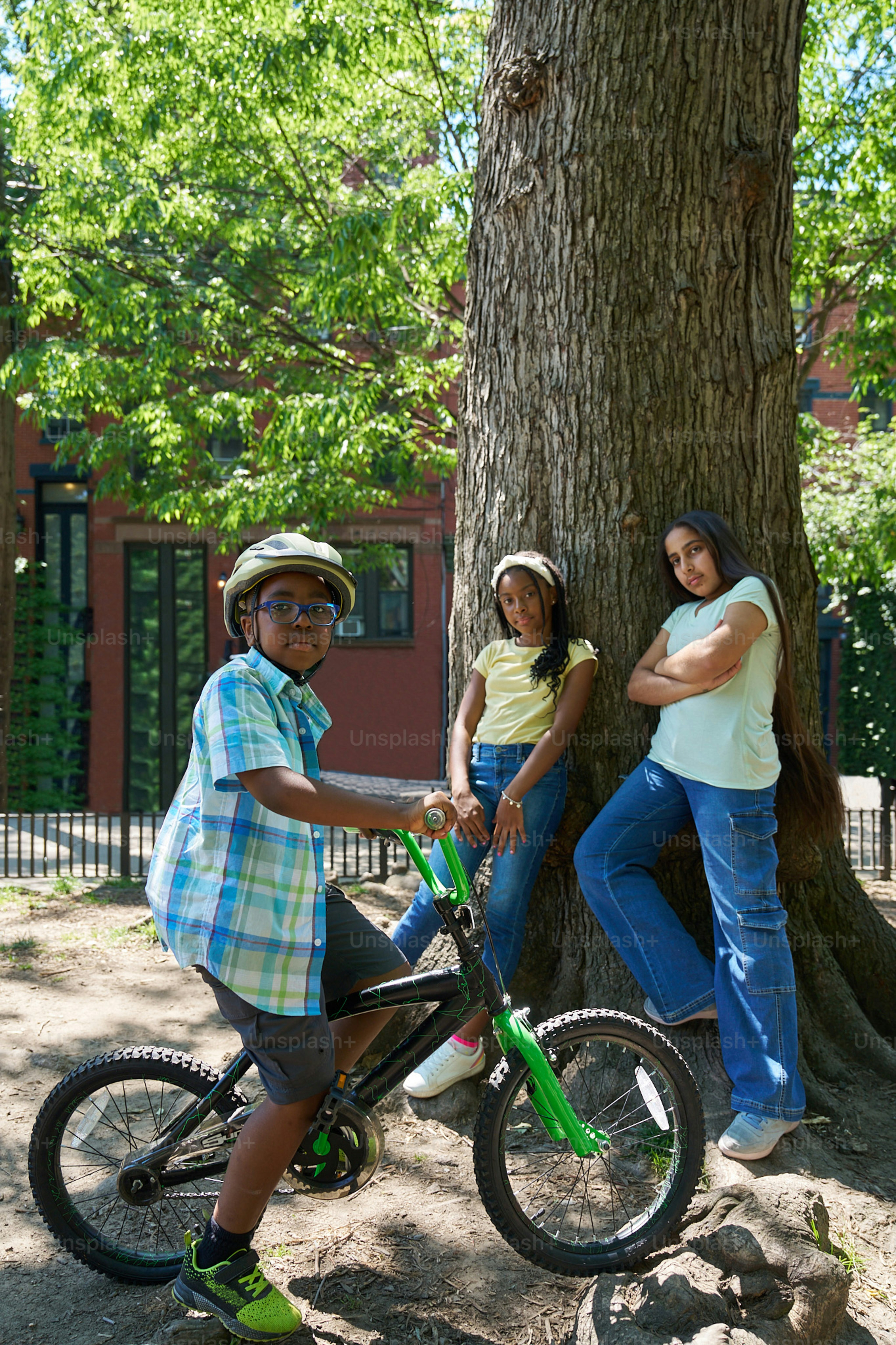 A group of people standing next to a tree