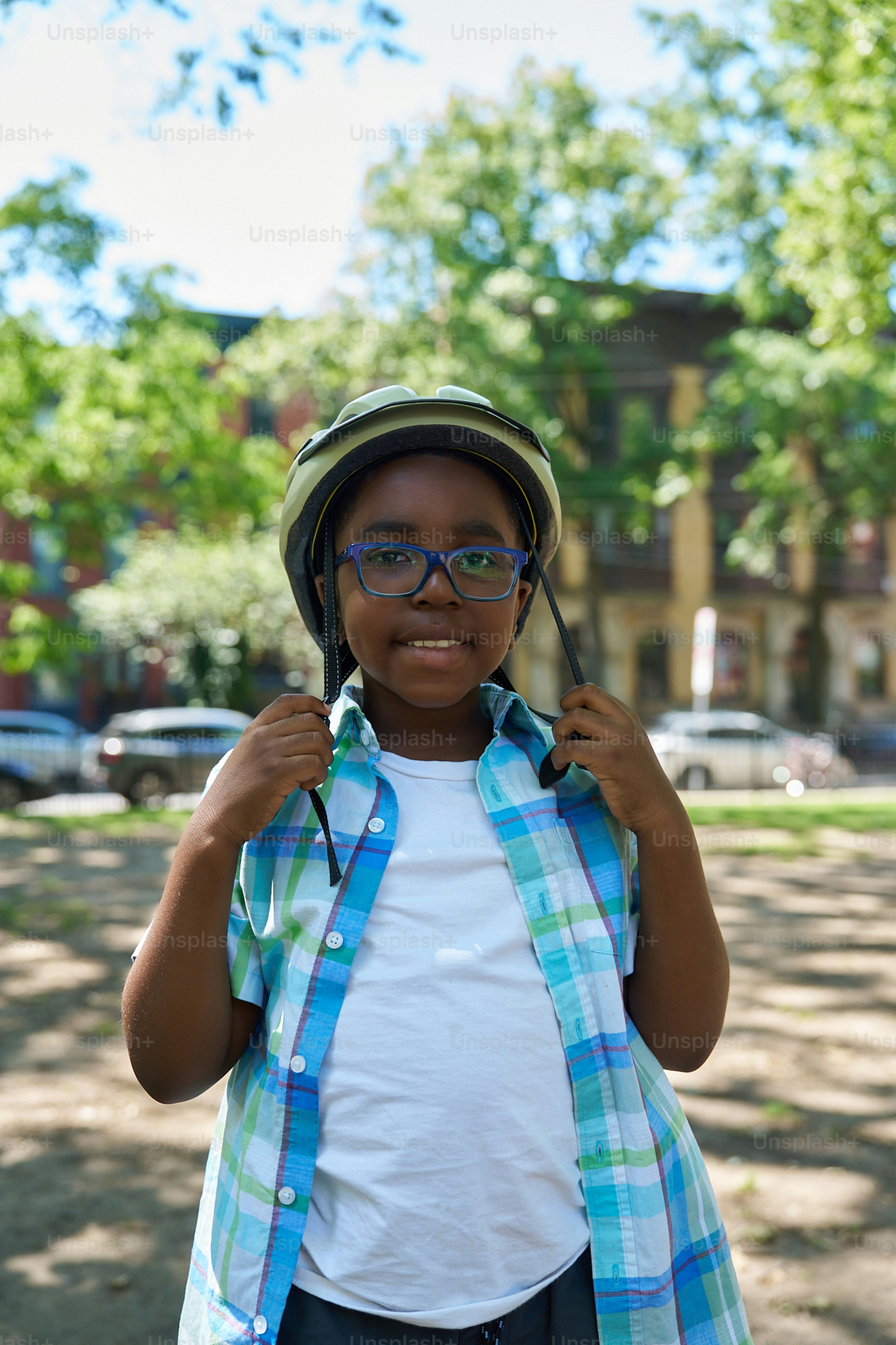 A young boy wearing a helmet and glasses
