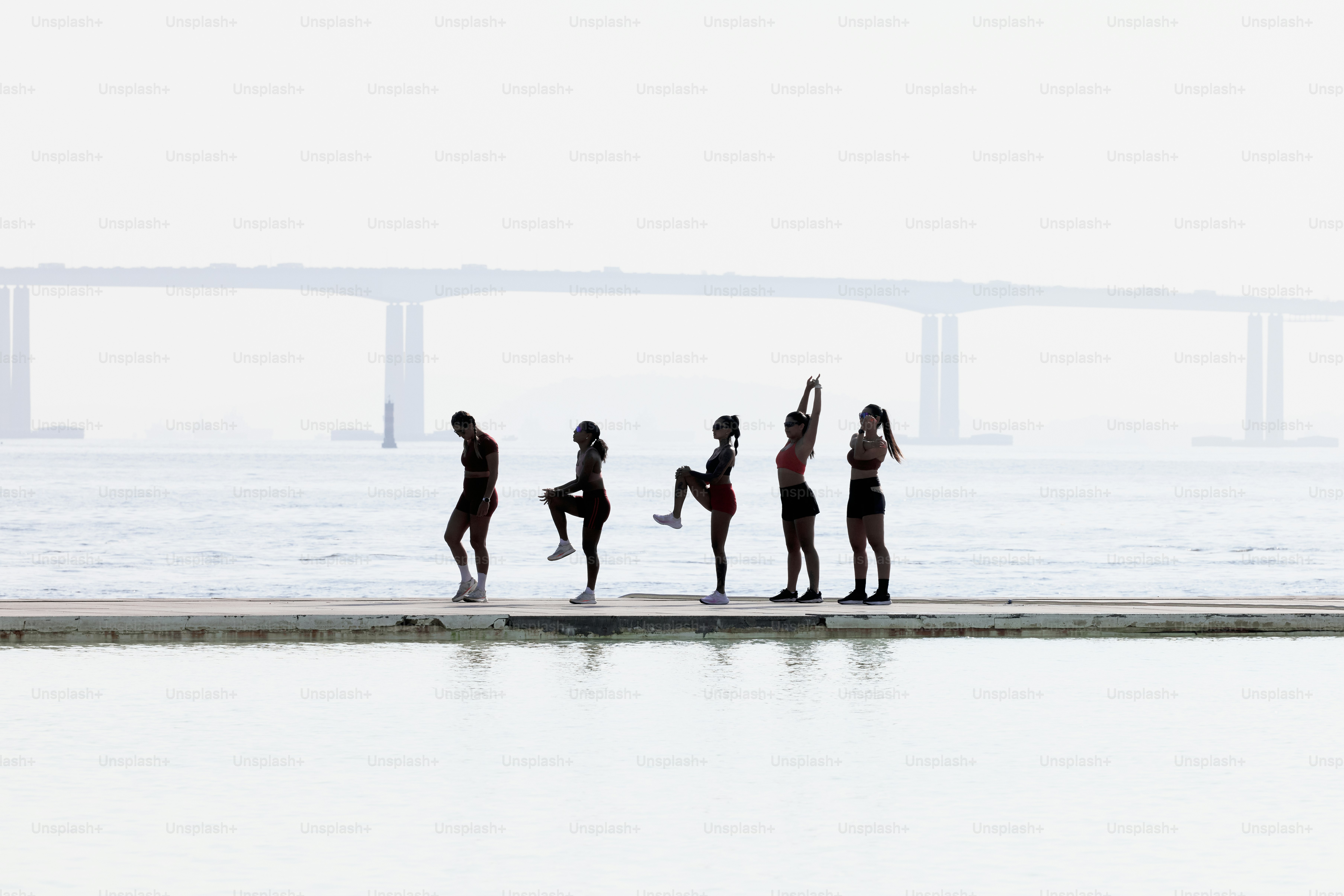 A group of people standing next to a body of water