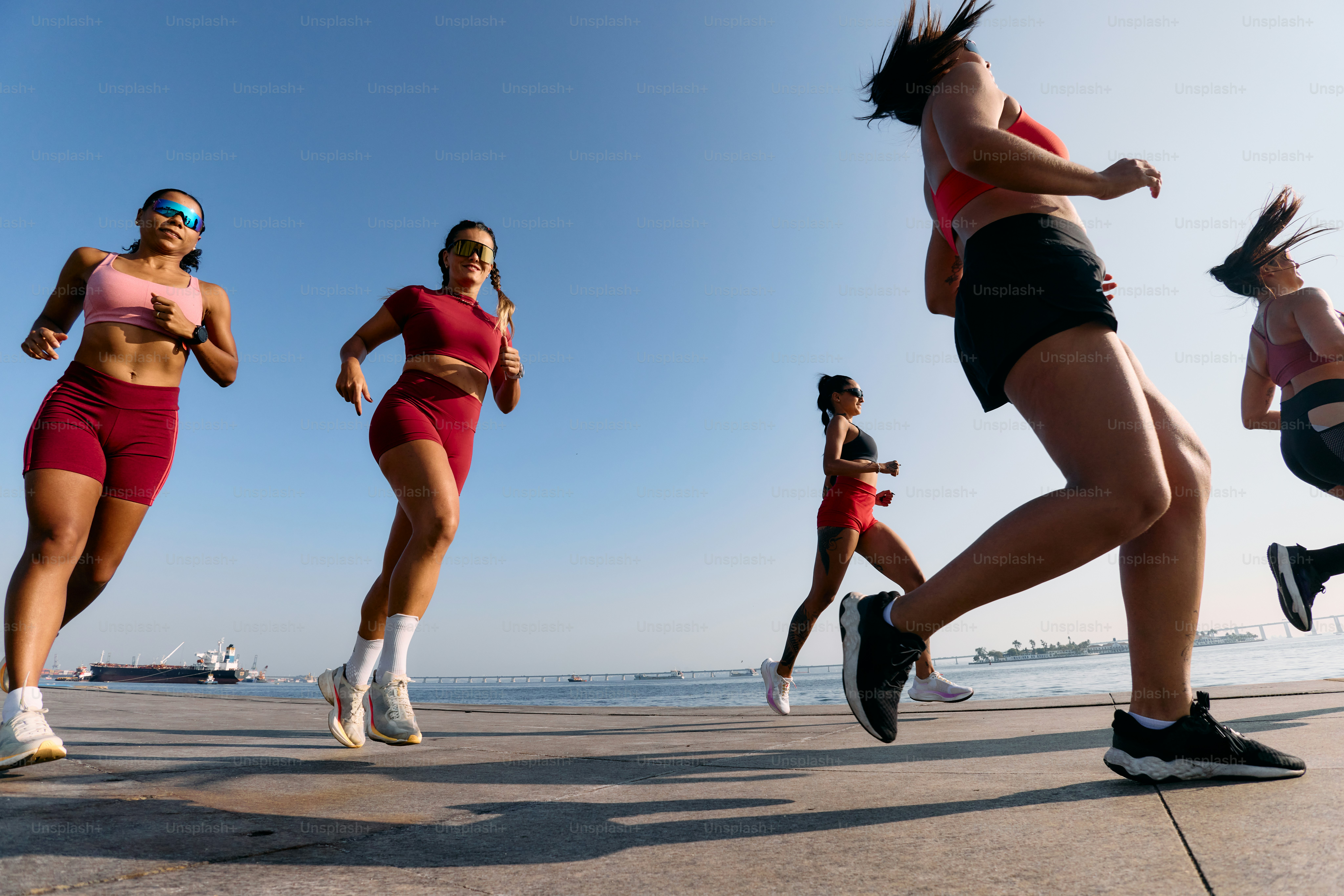 A group of women running on the beach photo – Running Image on Unsplash