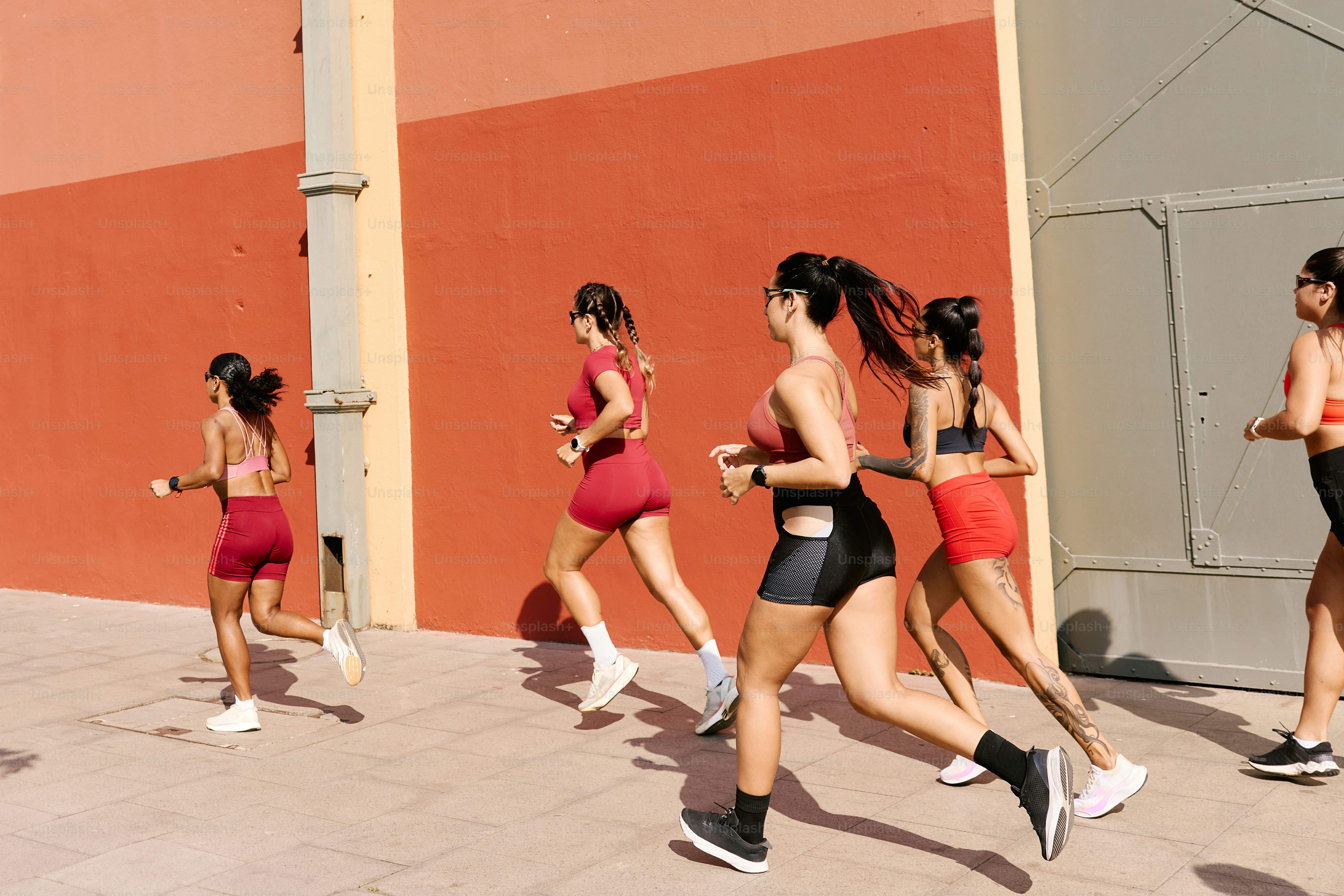 A group of women running down a street