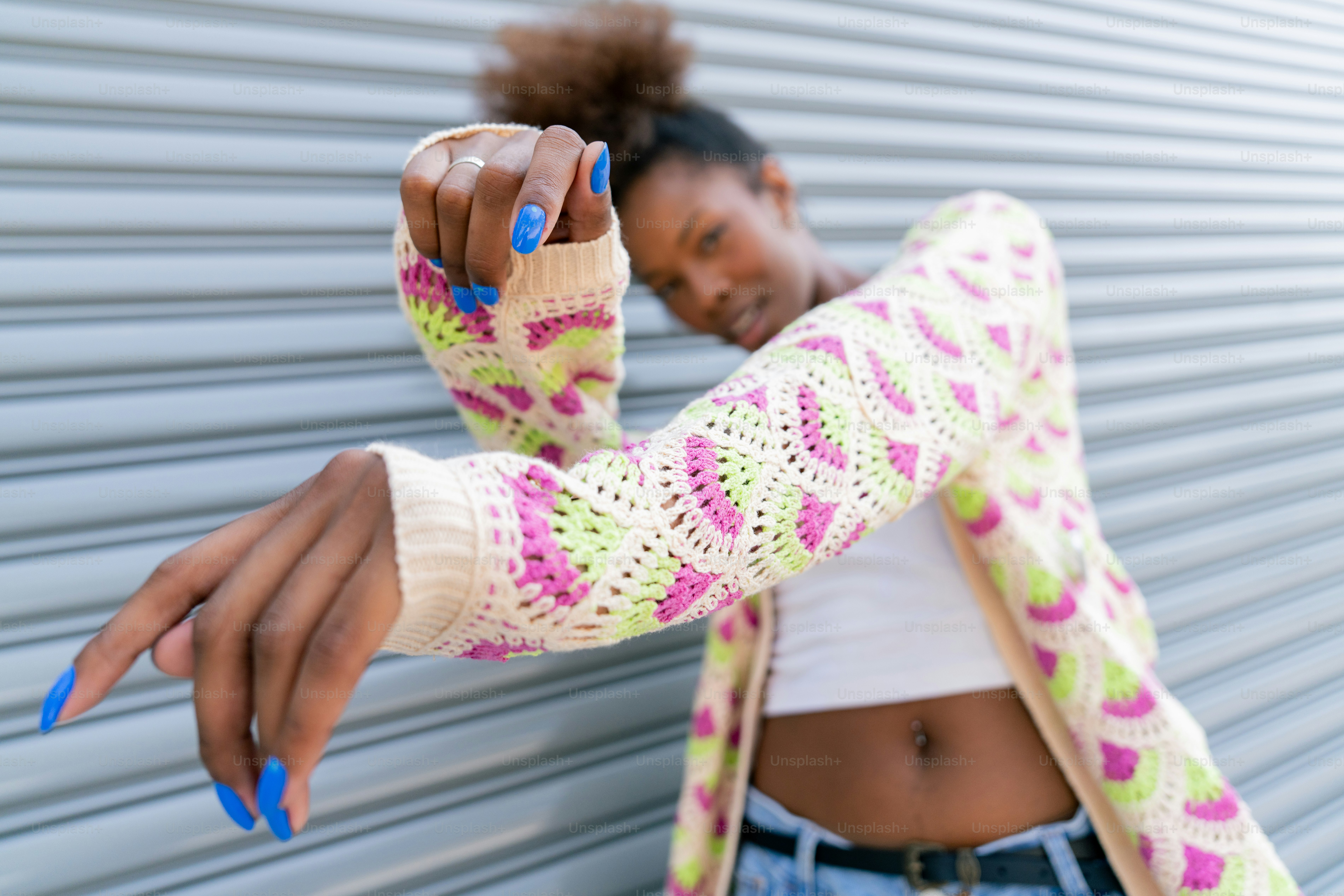 A woman with blue nails and a white top