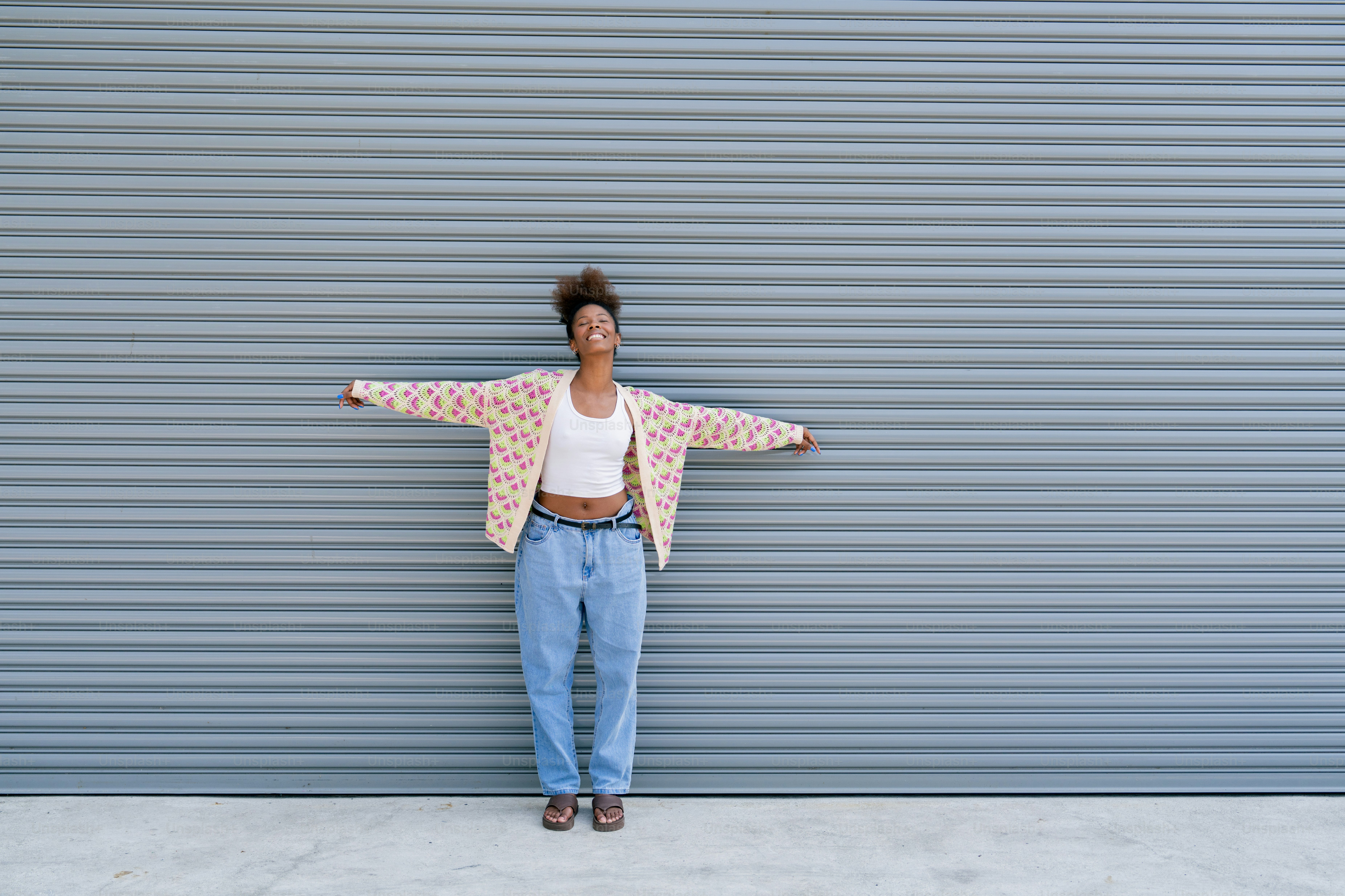 A woman standing in front of a garage door