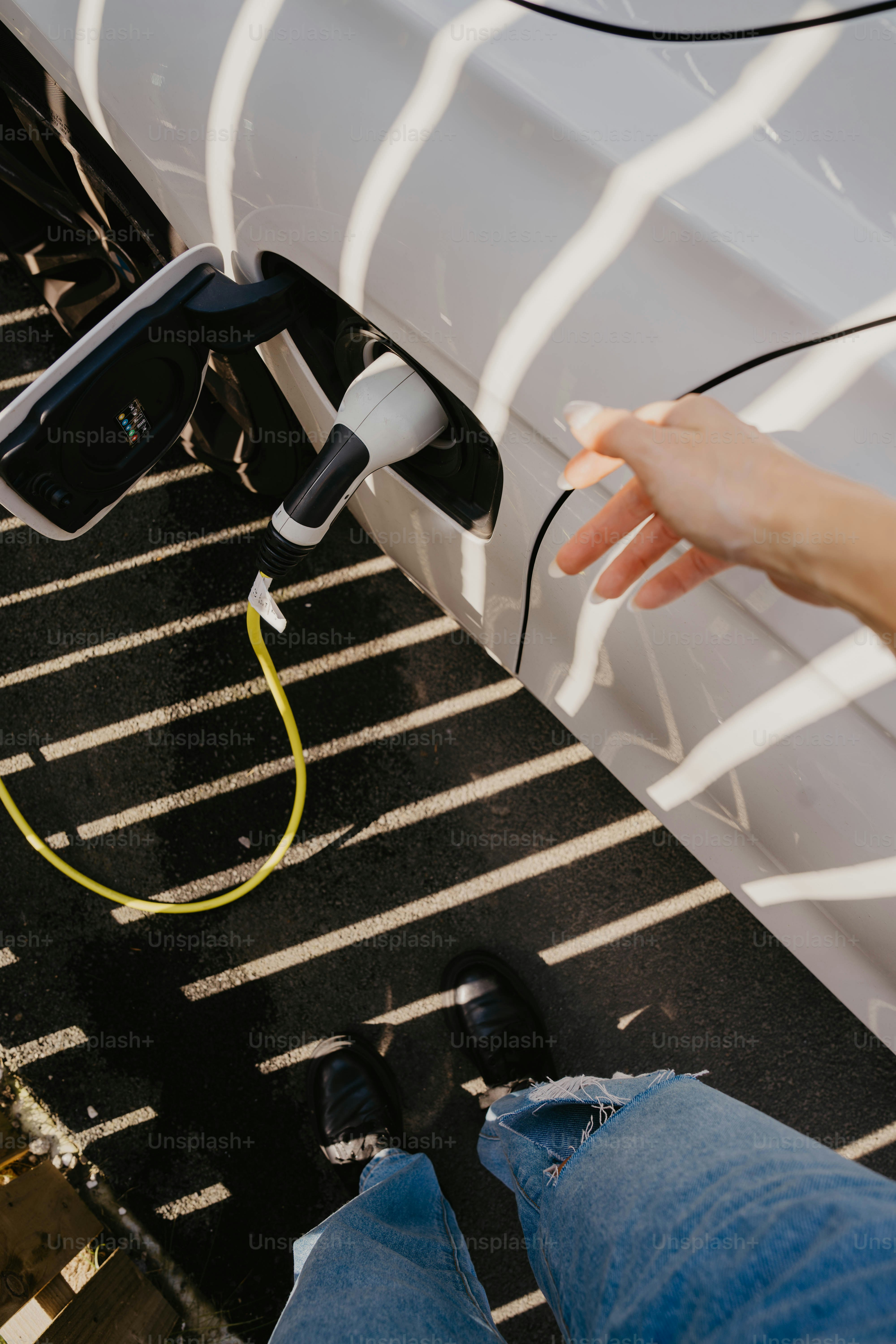 A person is charging a car with an electric charger