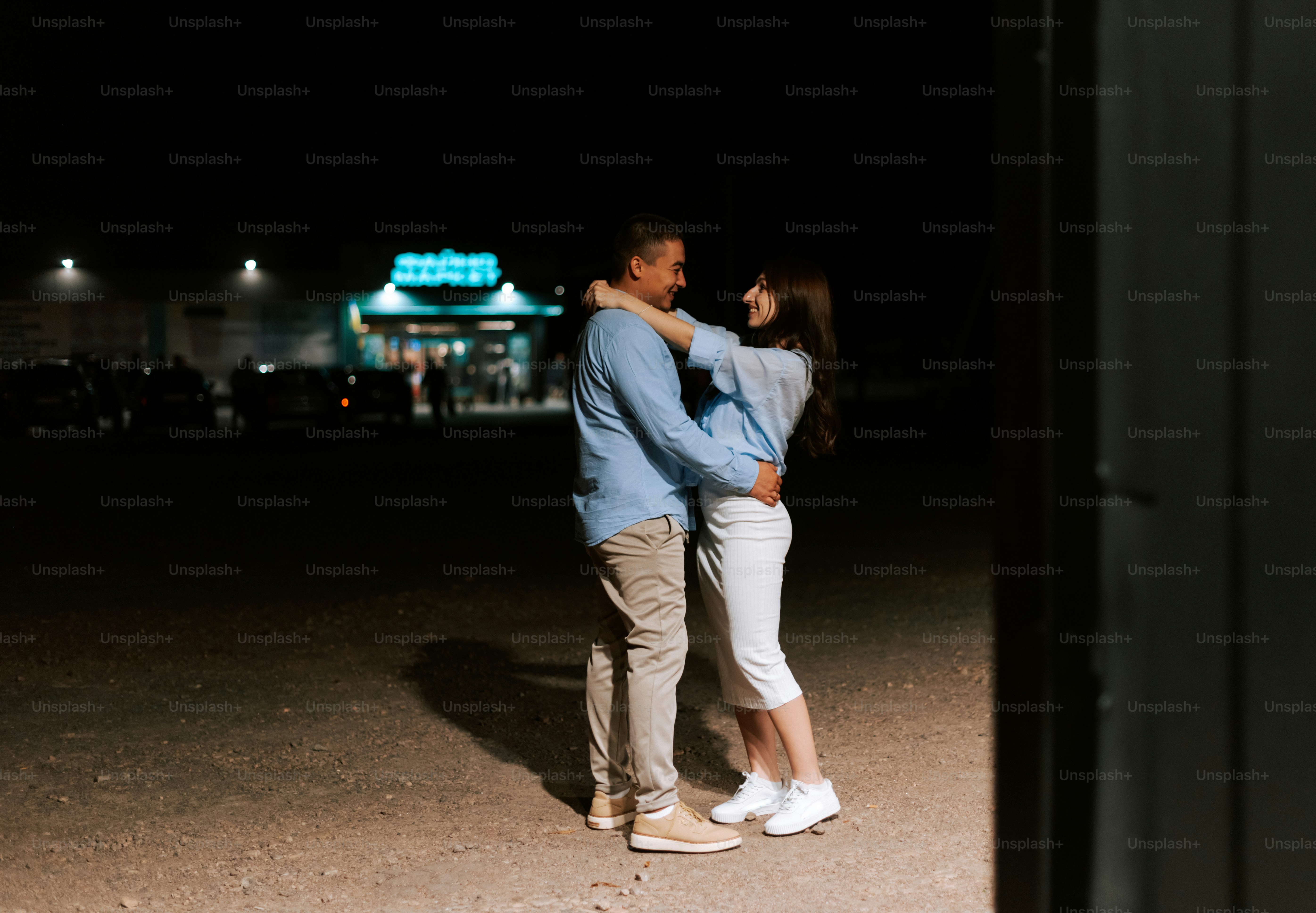 A man and a woman are standing in the dark photo – Couple Image on Unsplash