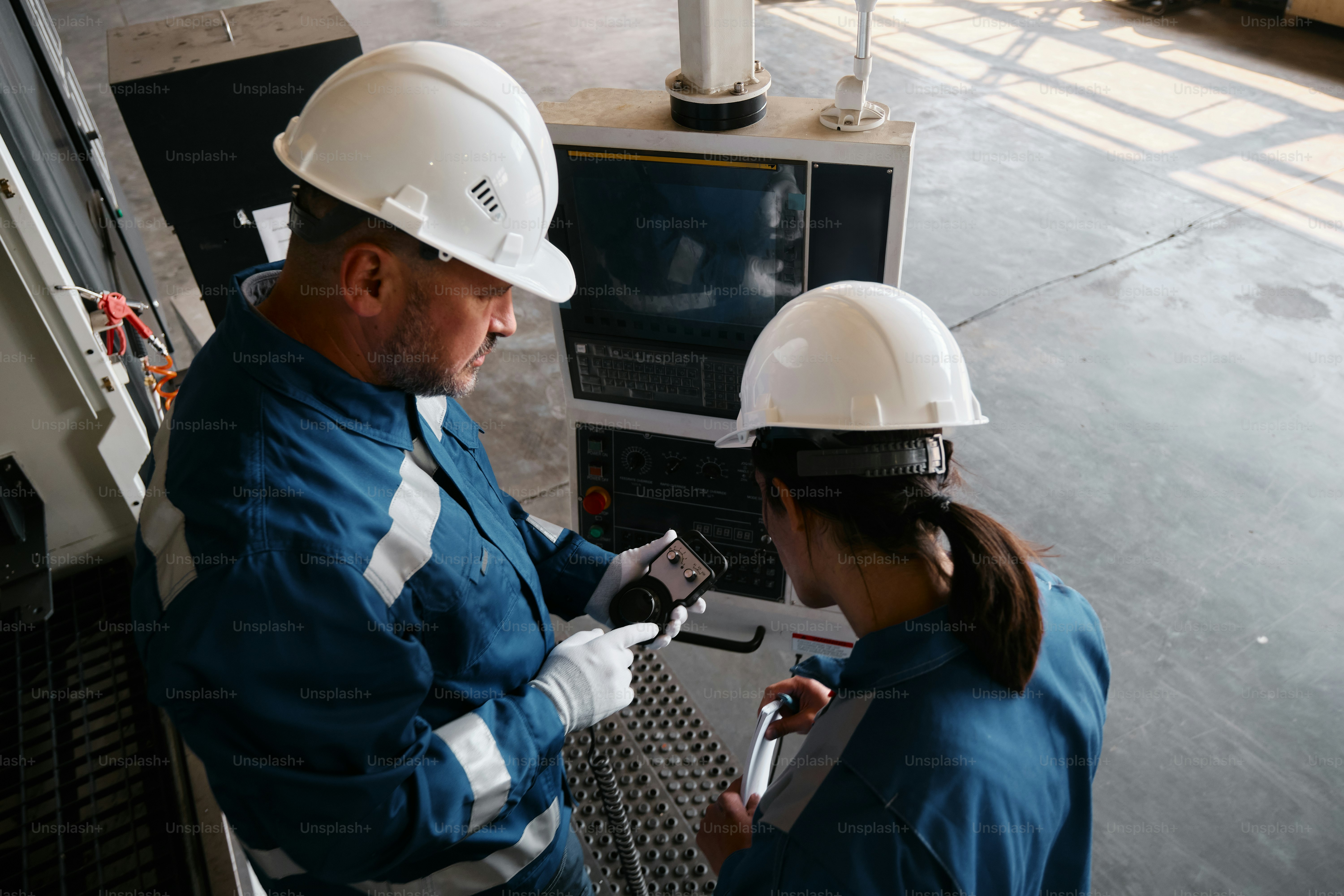 A man and a woman wearing hard hats