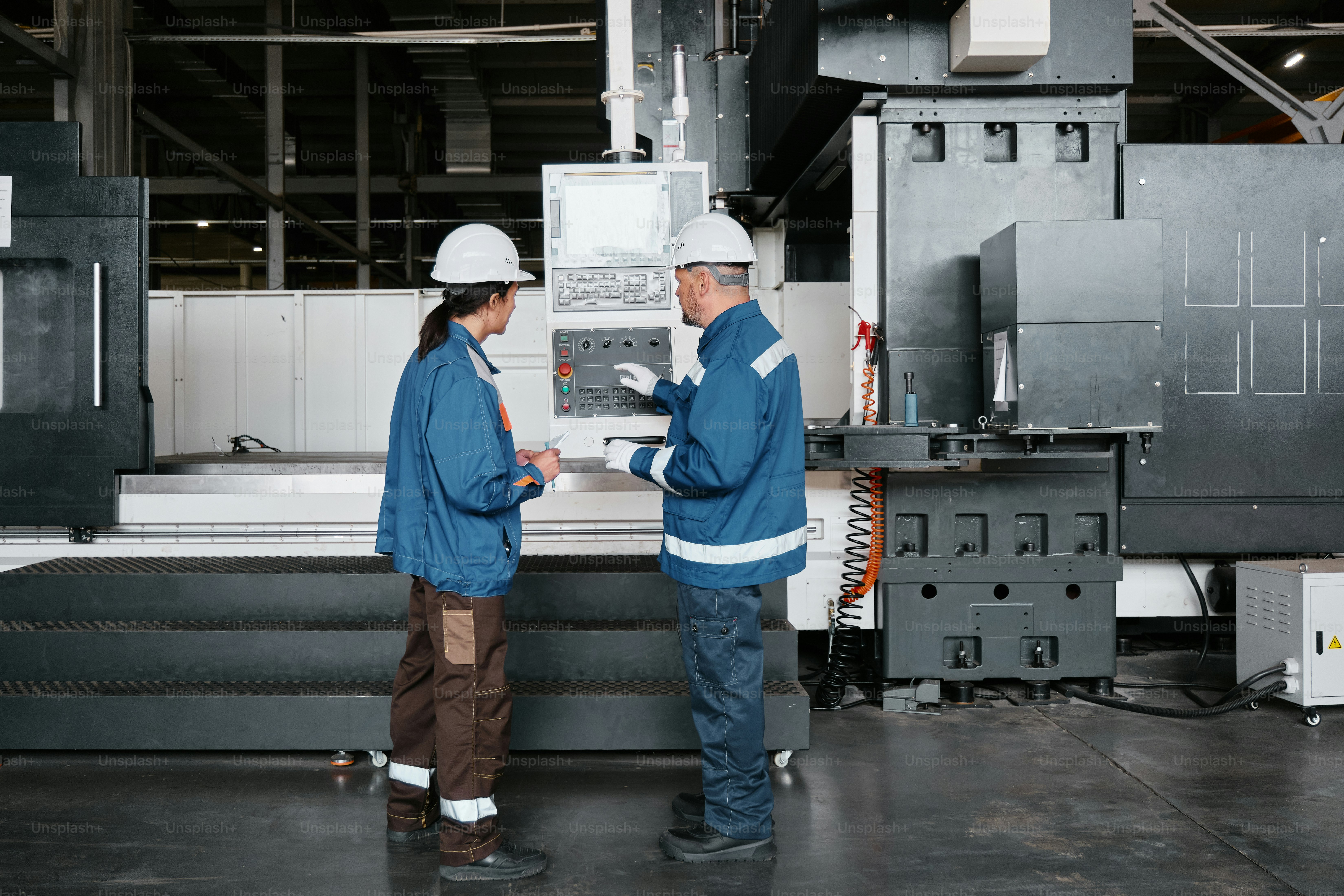 Two people standing in front of a machine