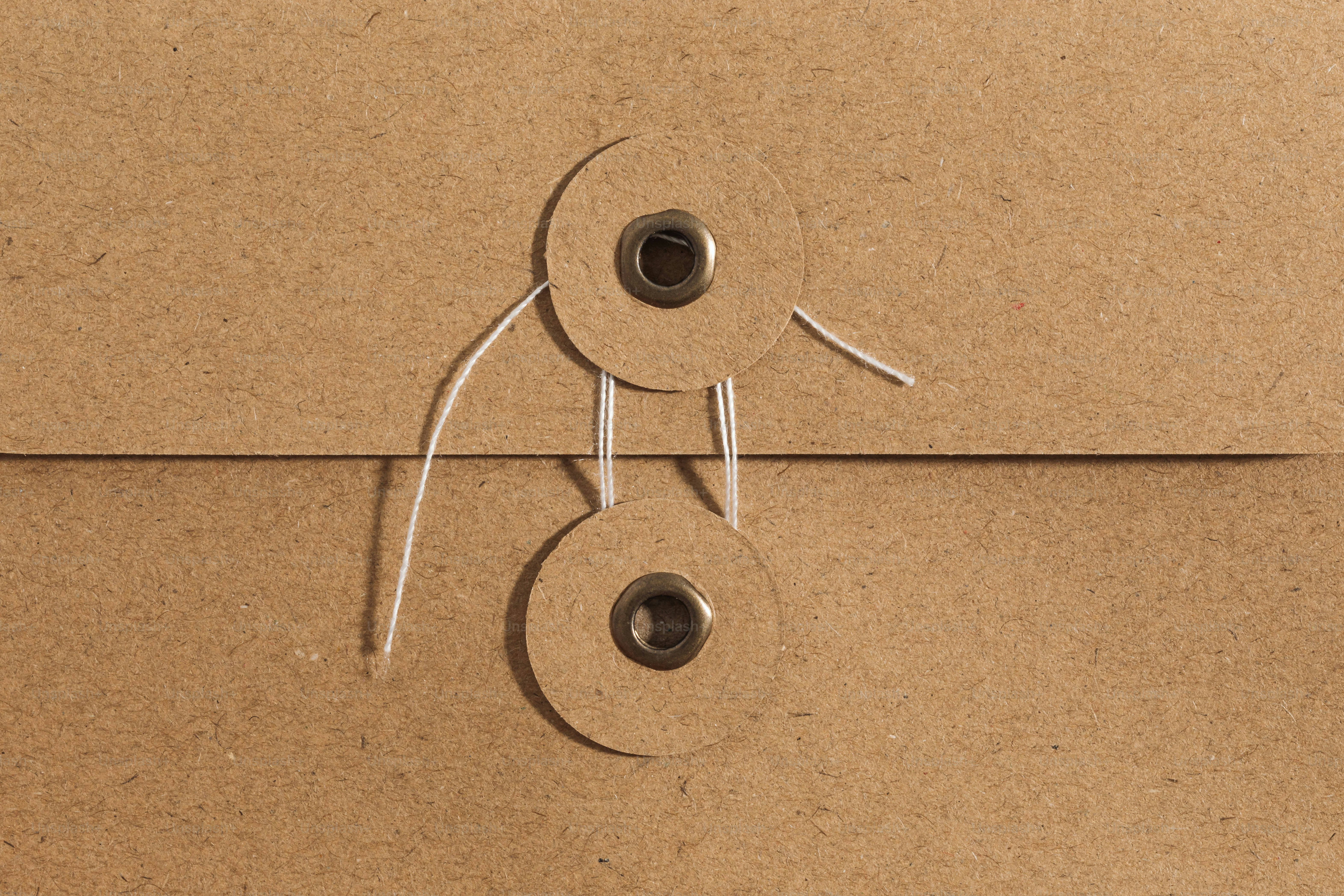 A close up of a brown envelope with a hole in the middle