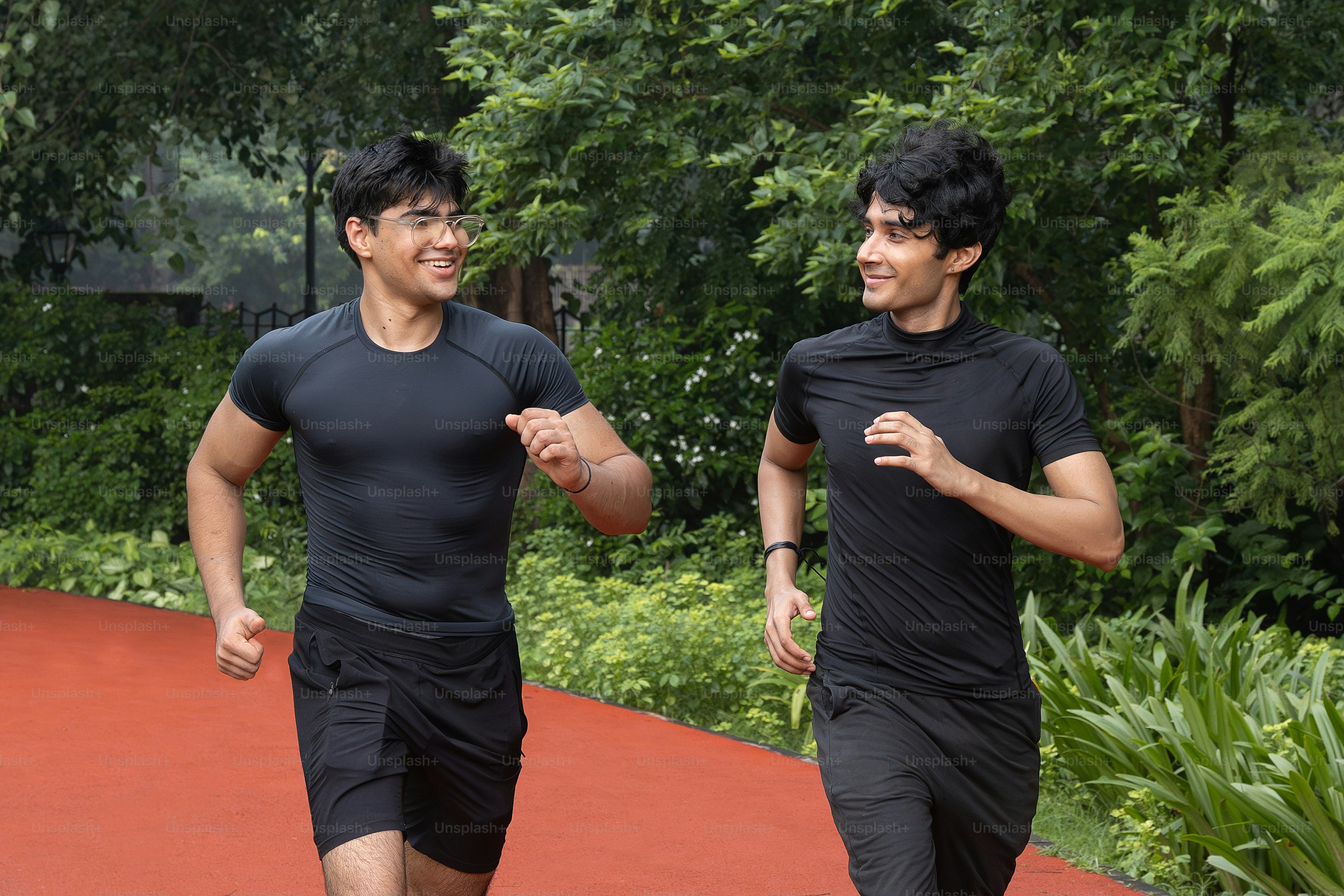 A couple of men that are running on a court