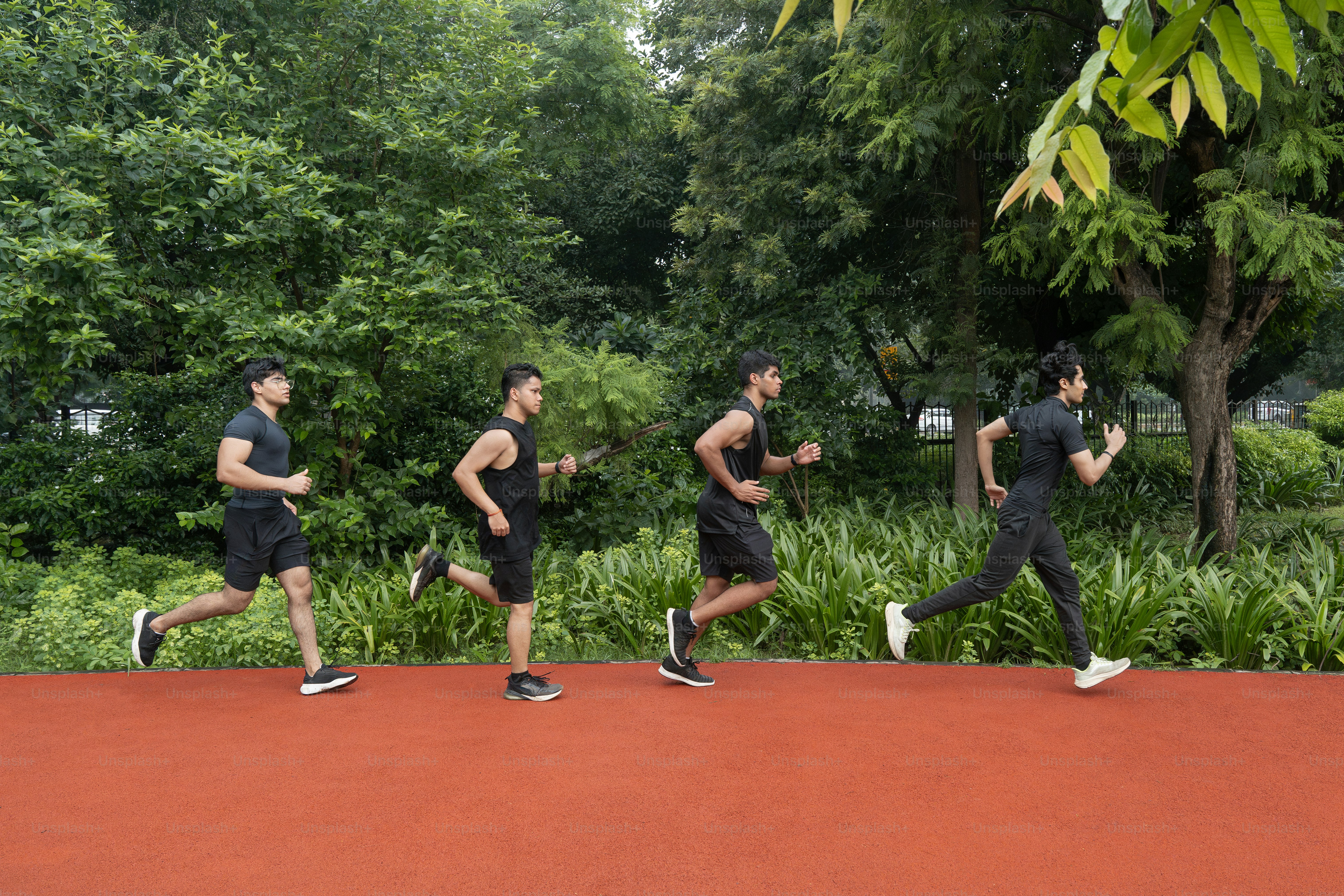 A group of men running down a road photo – Green Image on Unsplash