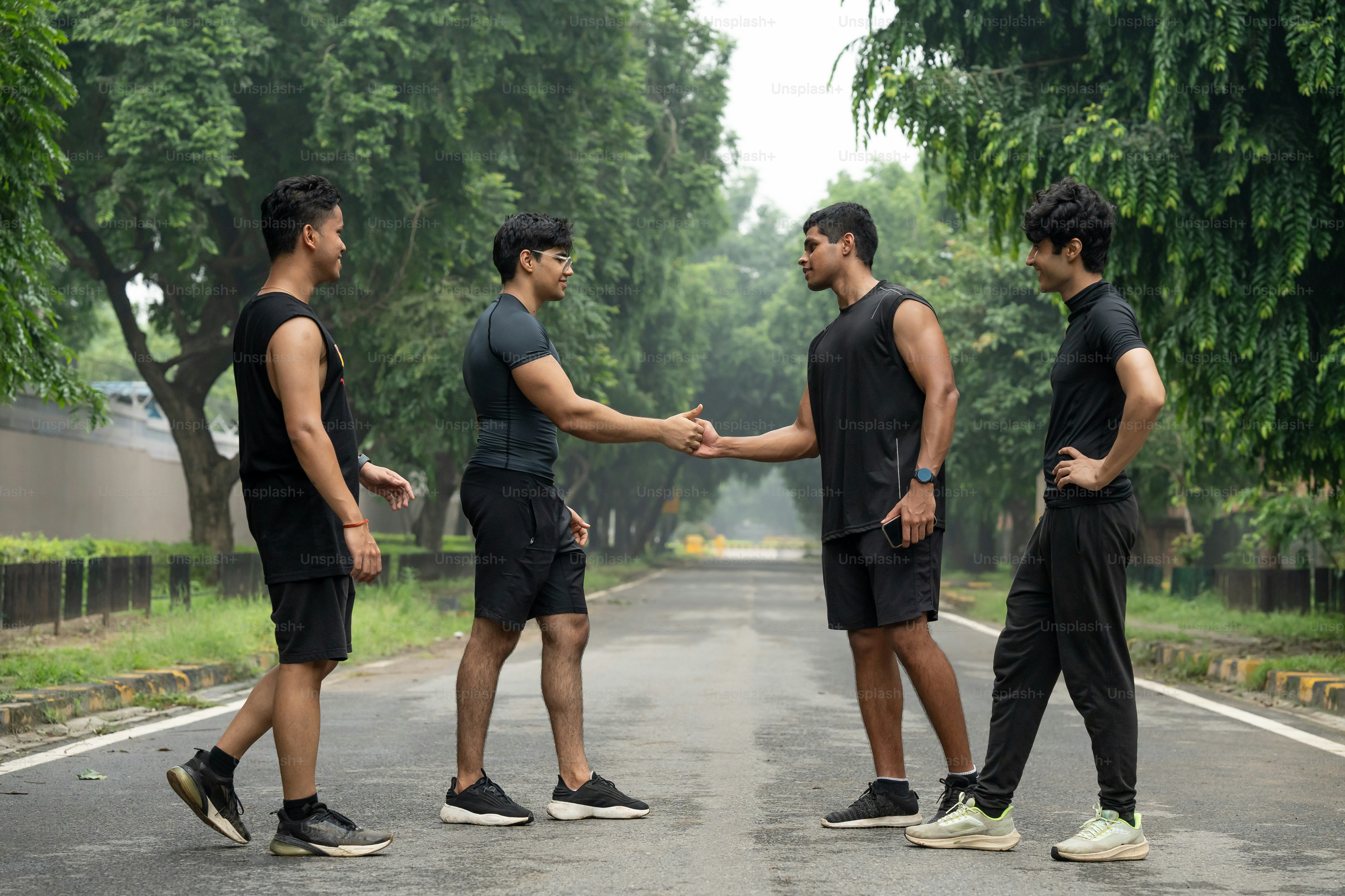 A group of men running down a road photo – Green Image on Unsplash