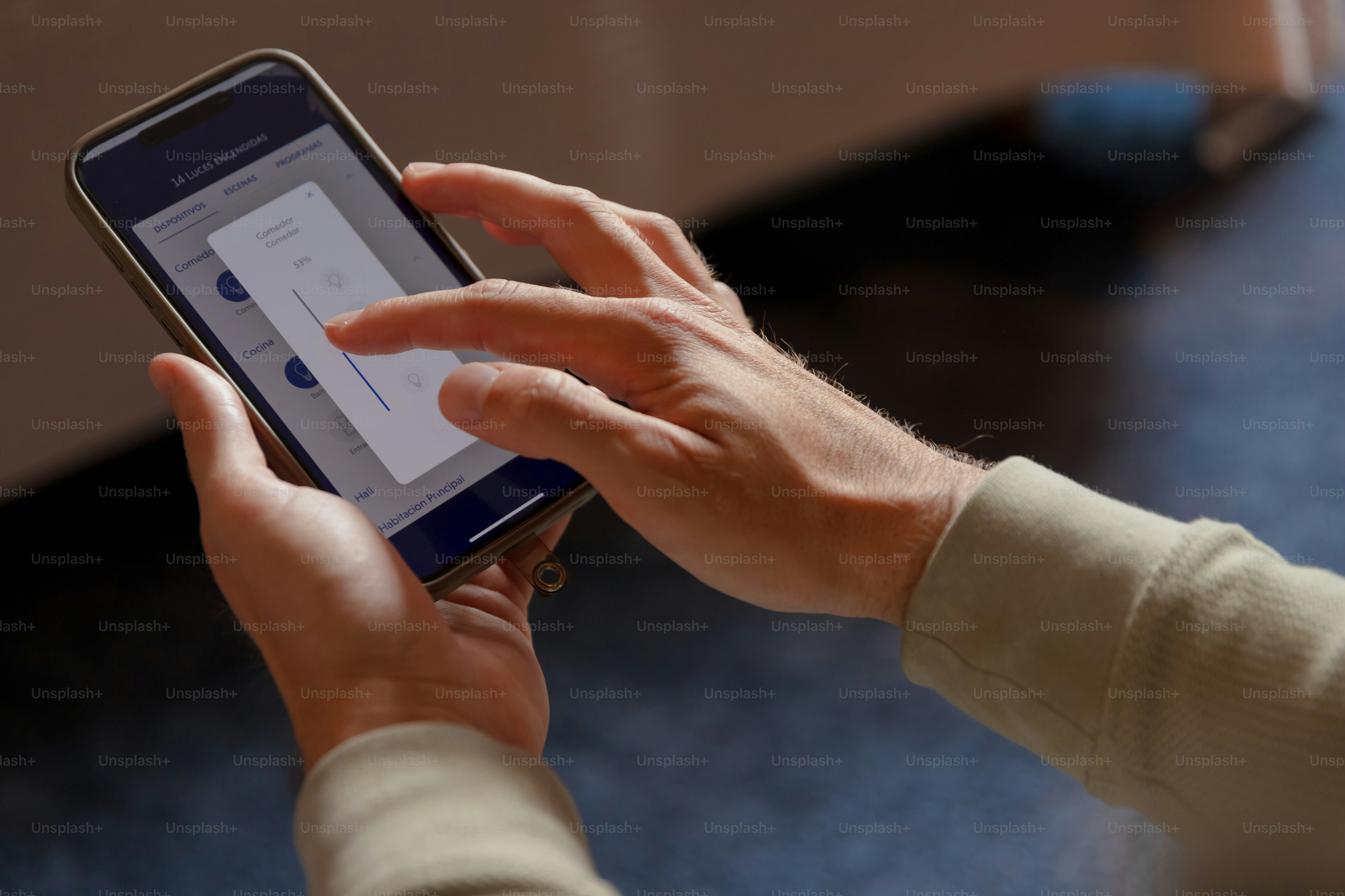 A person holding a smart phone in their hands