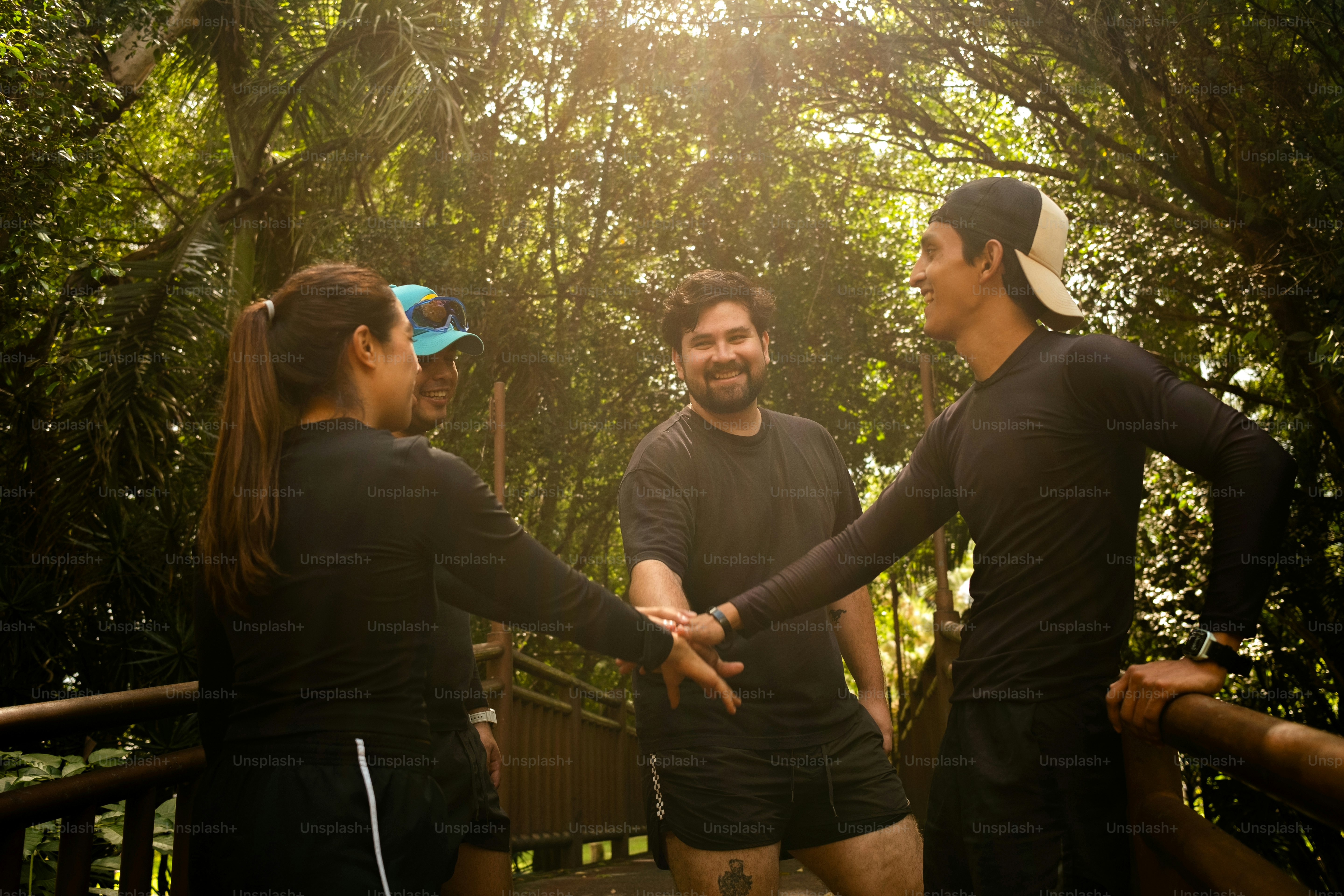 A group of people standing on top of a wooden bridge