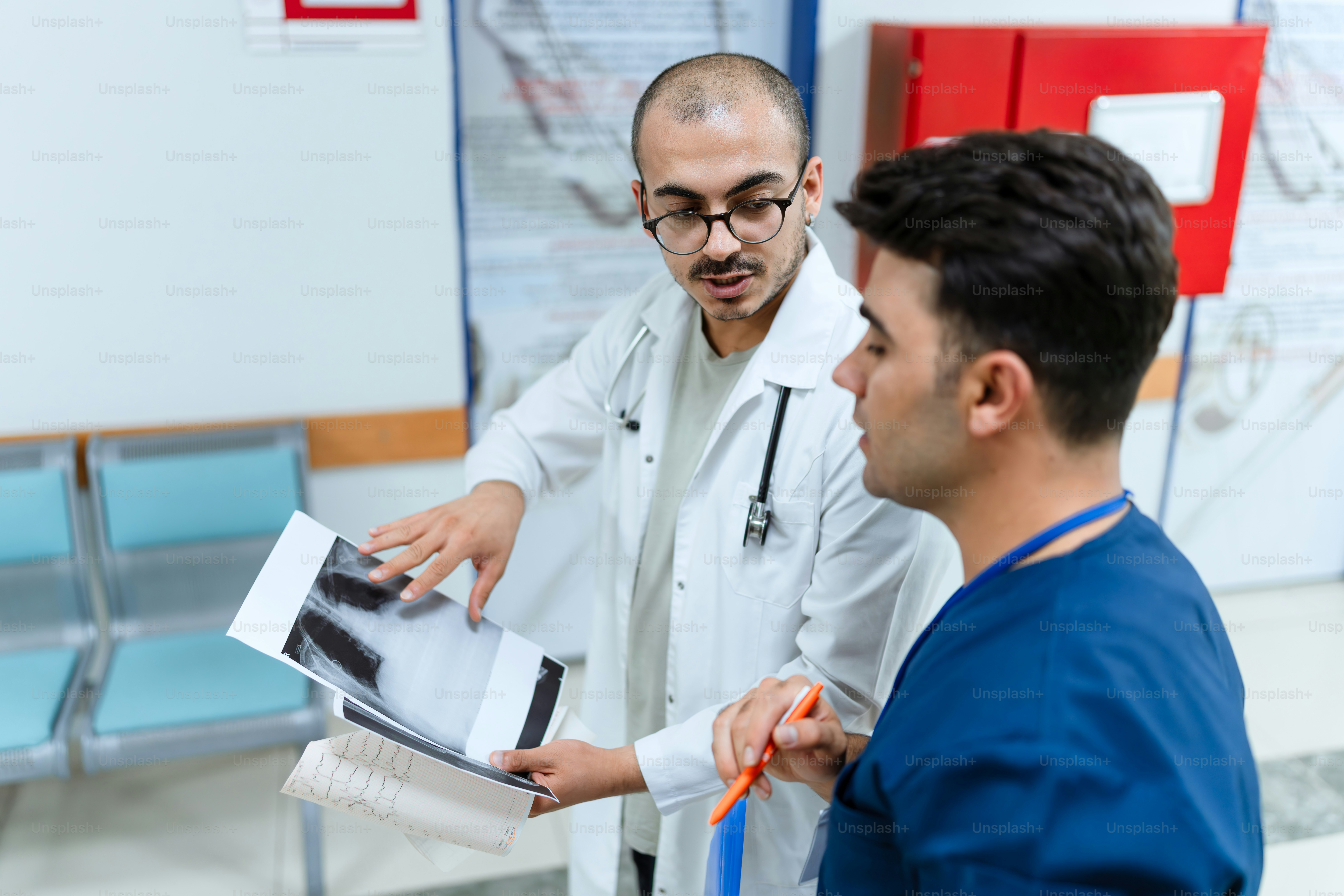 Two doctors looking at a clipboard in a hospital