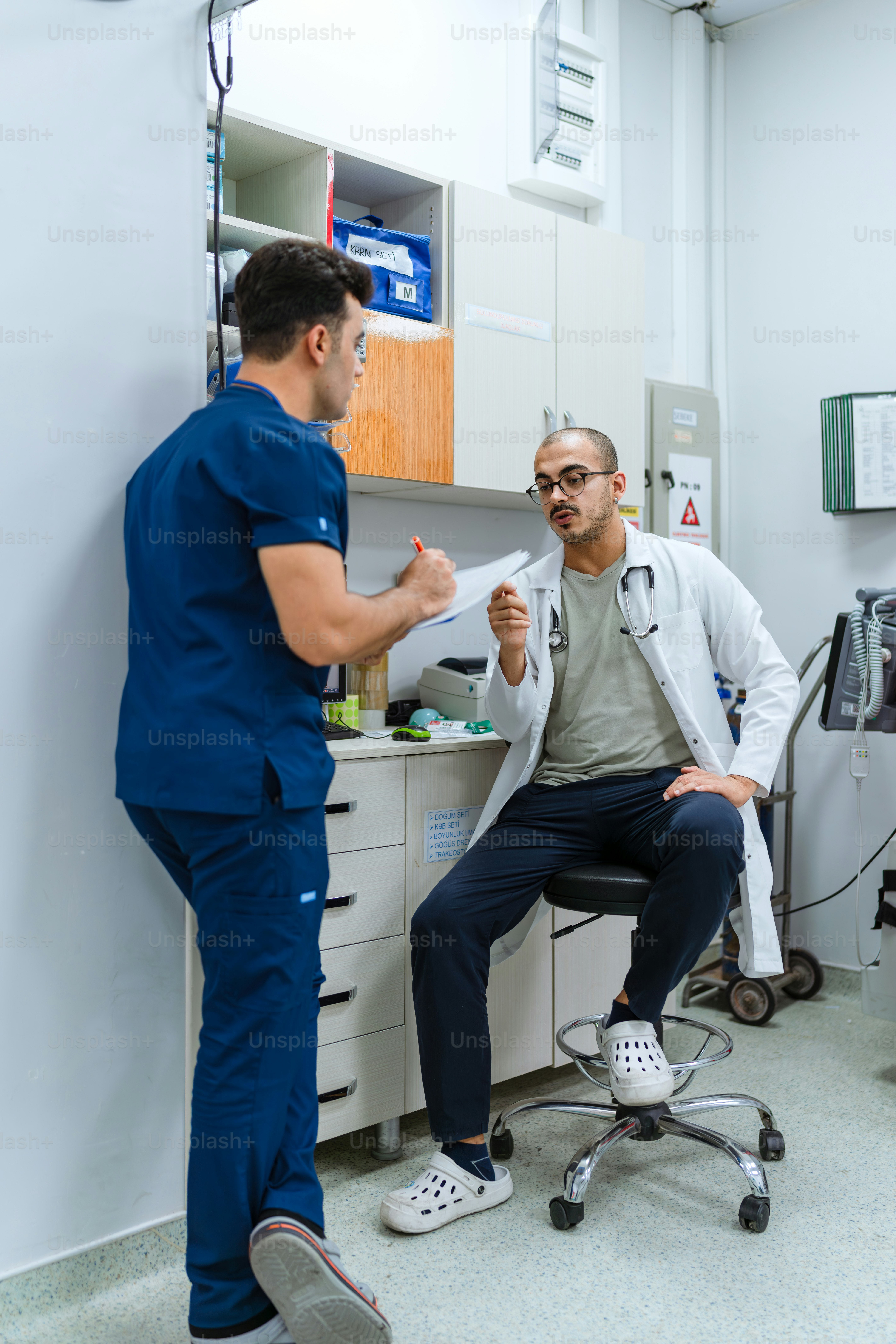 A doctor talking to a patient in a room