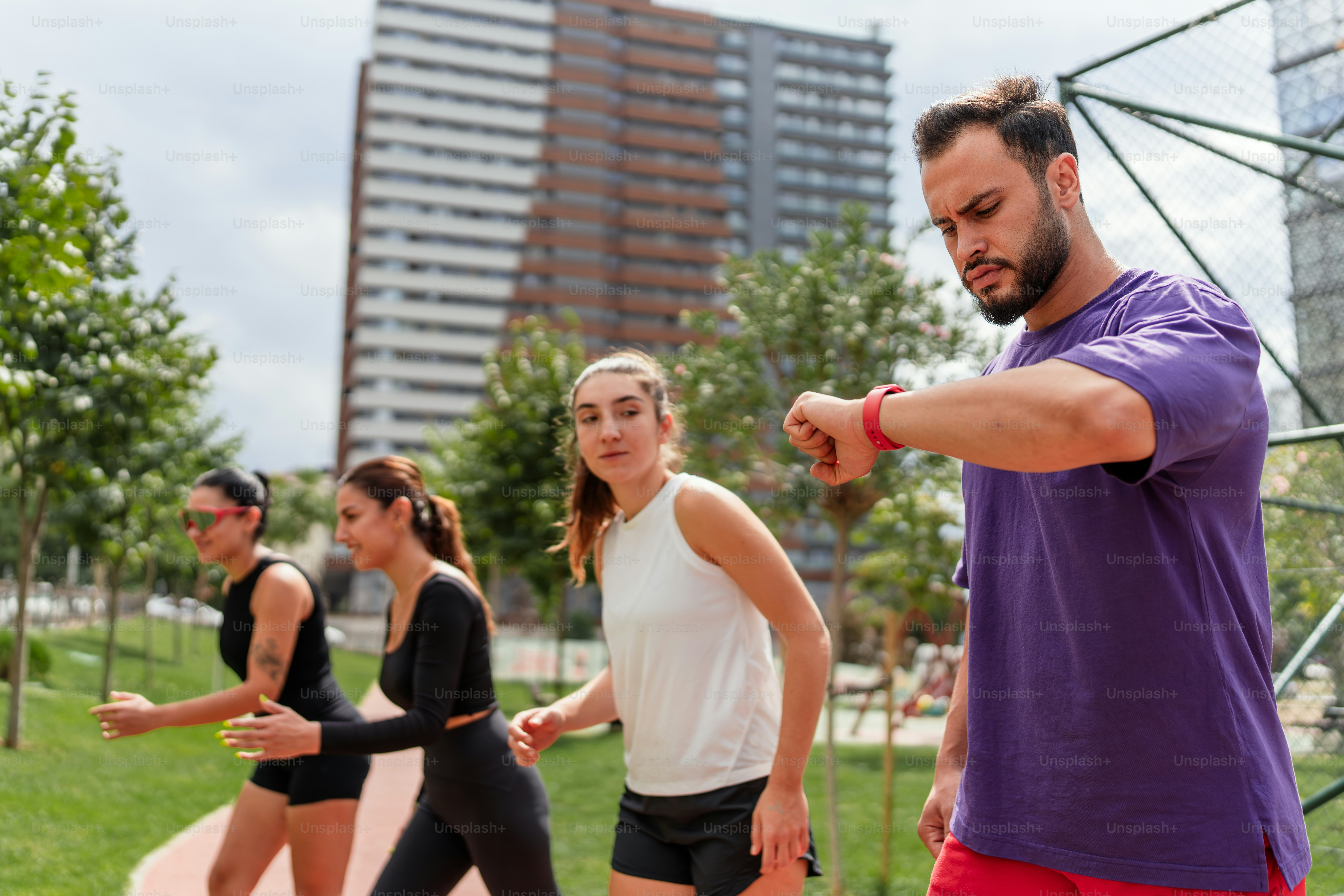 A group of people doing exercises in a park
