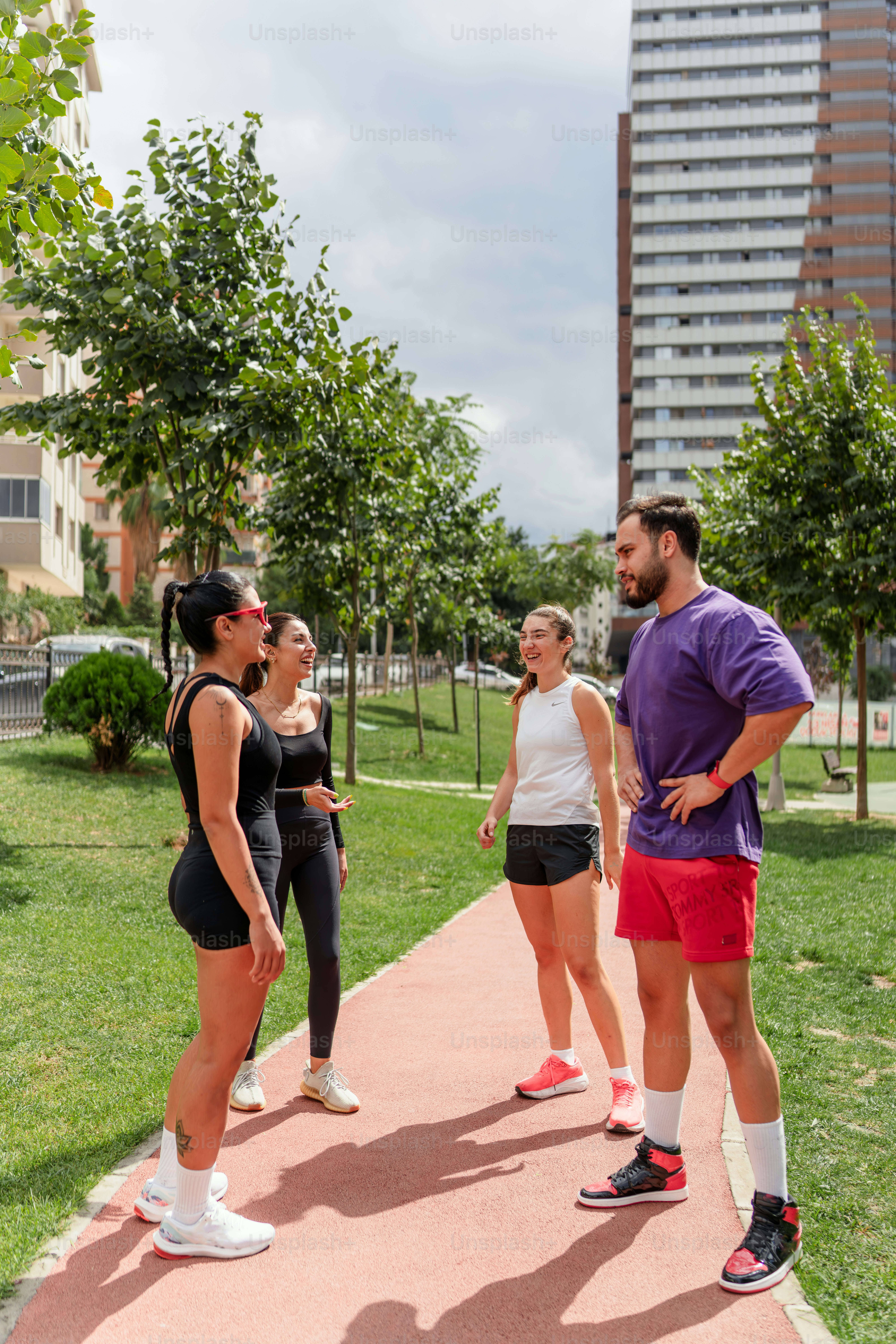 A group of people standing on top of a sidewalk