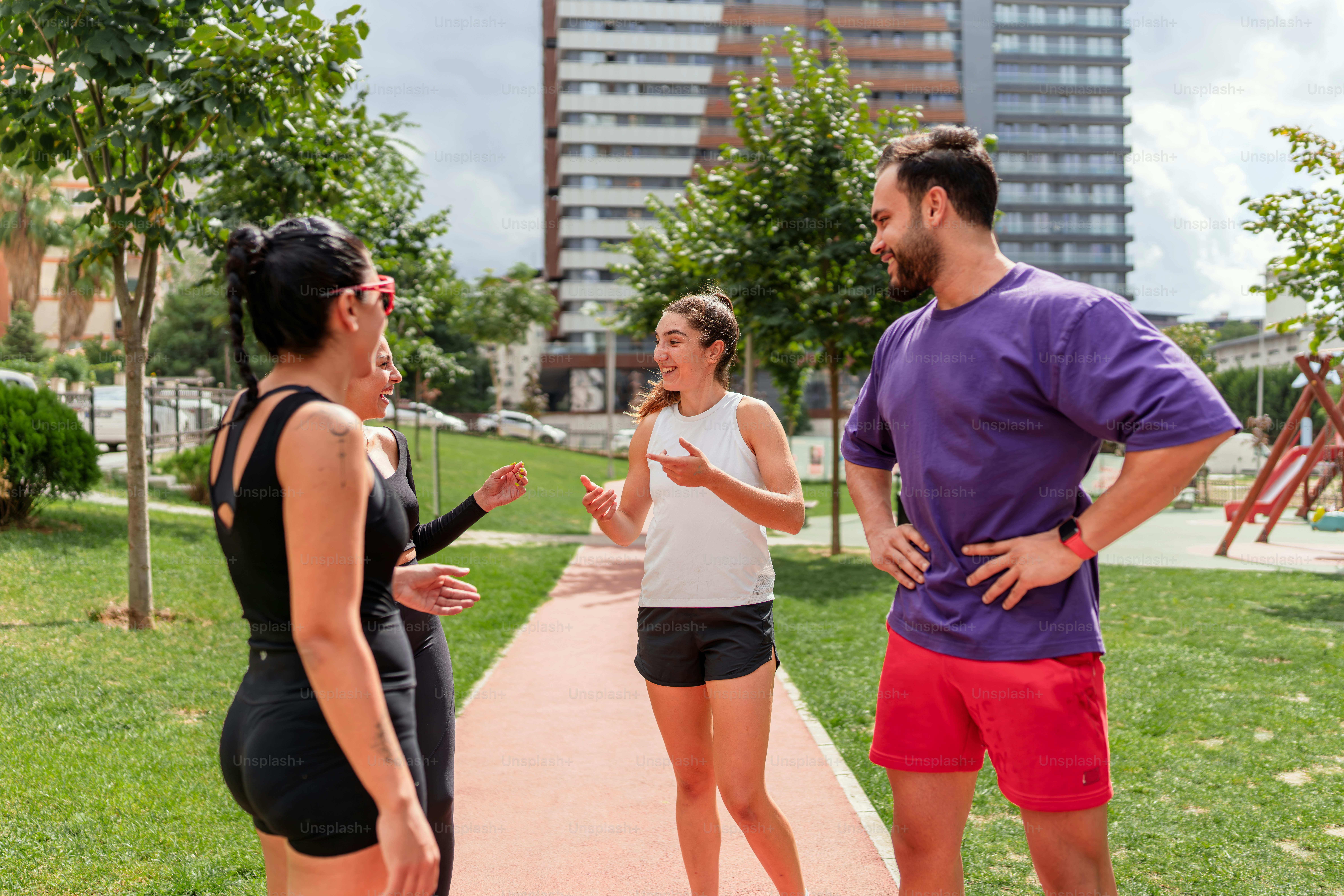 A group of people standing around talking to each other