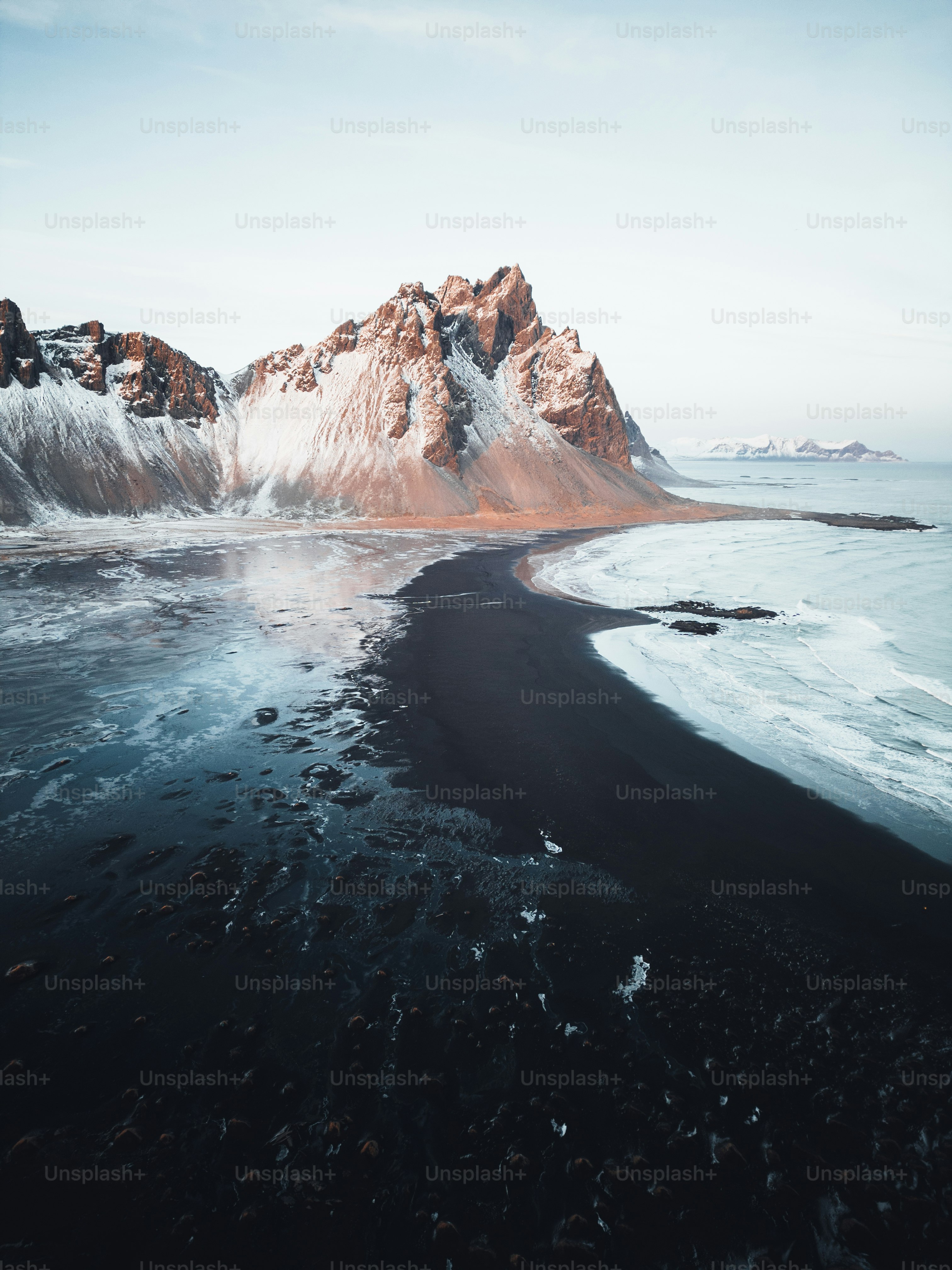 An aerial view of a mountain and a body of water