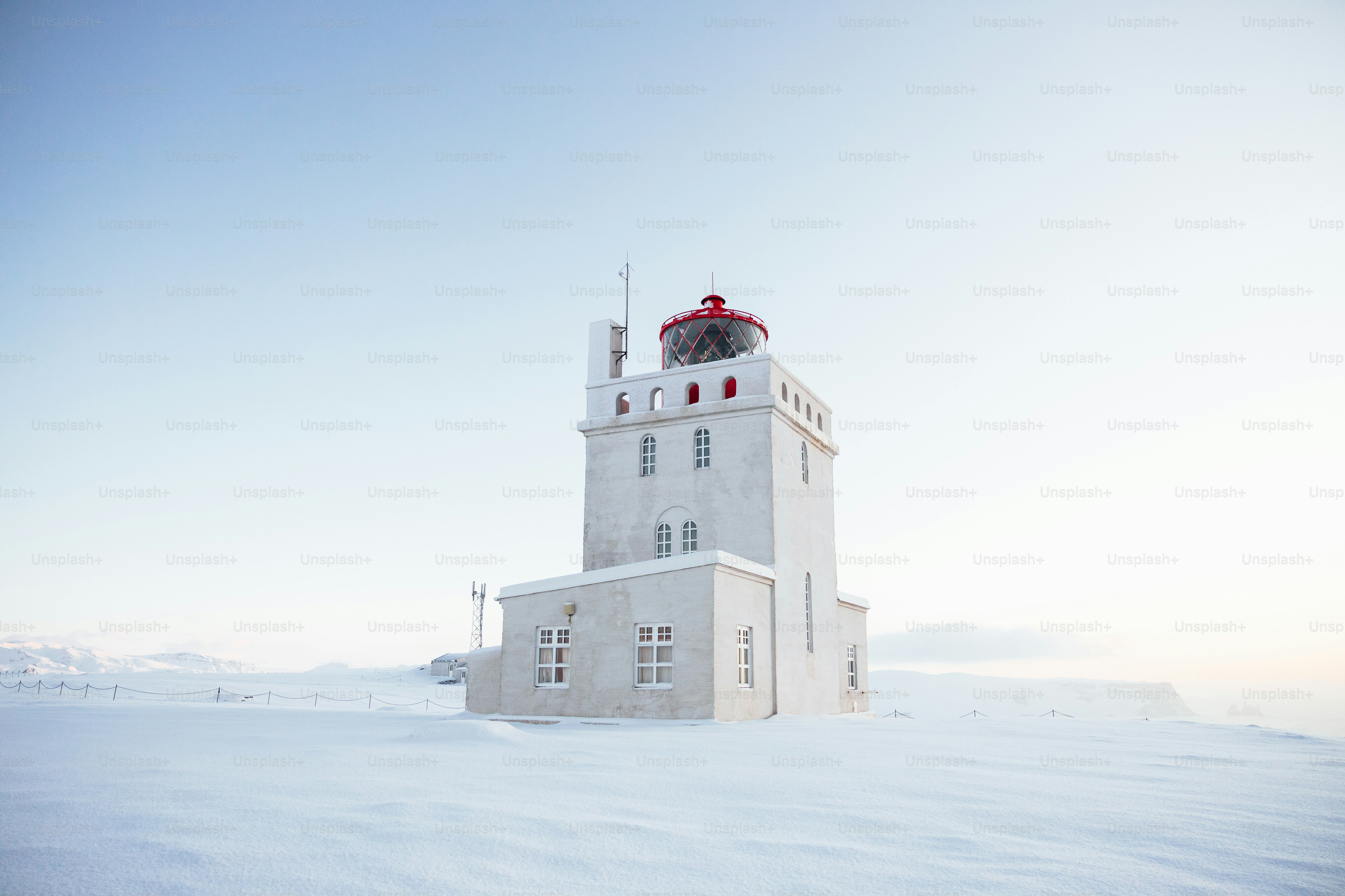A white tower with a clock on top of it