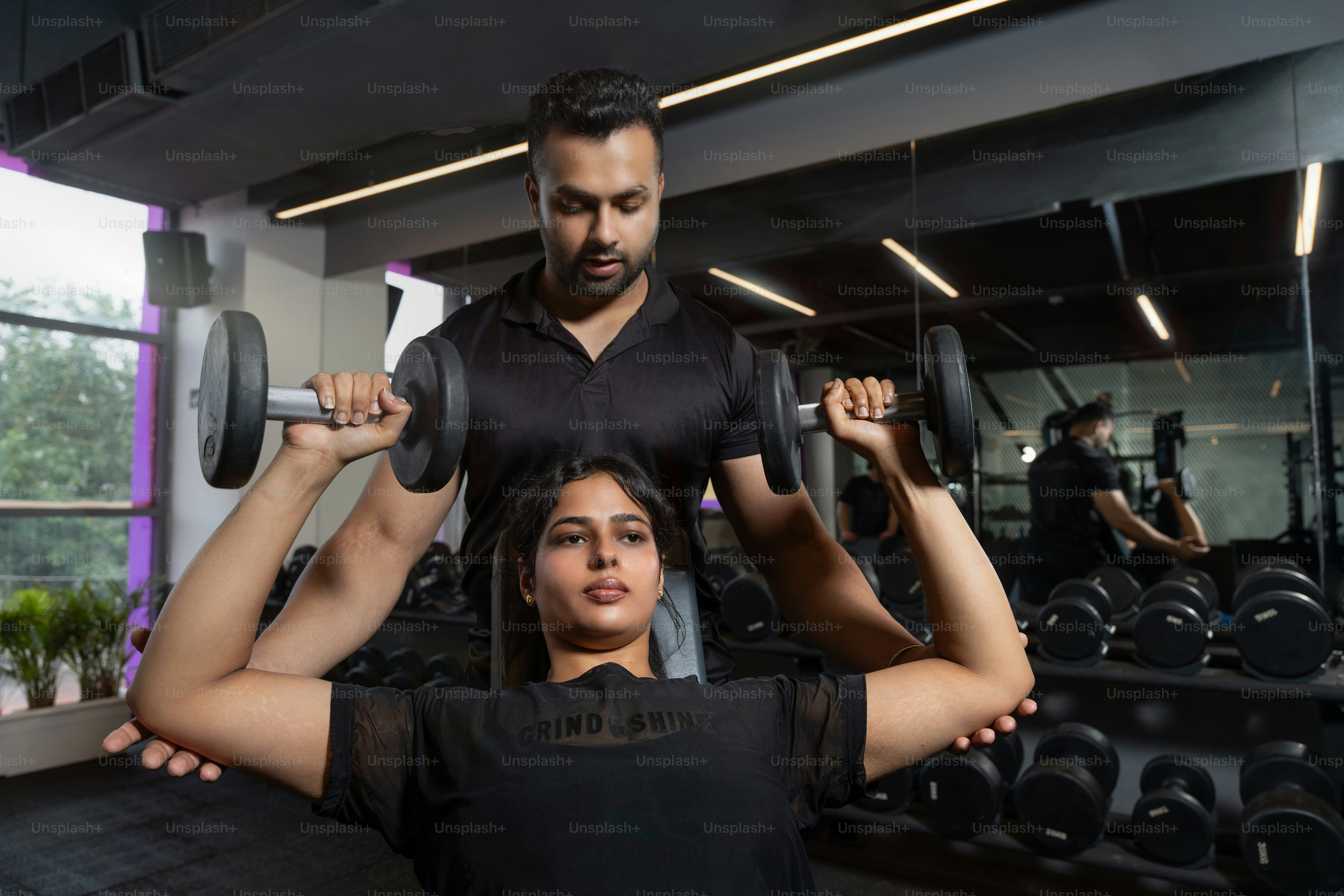 A man and a woman doing exercises in a gym photo – Gym Image on Unsplash