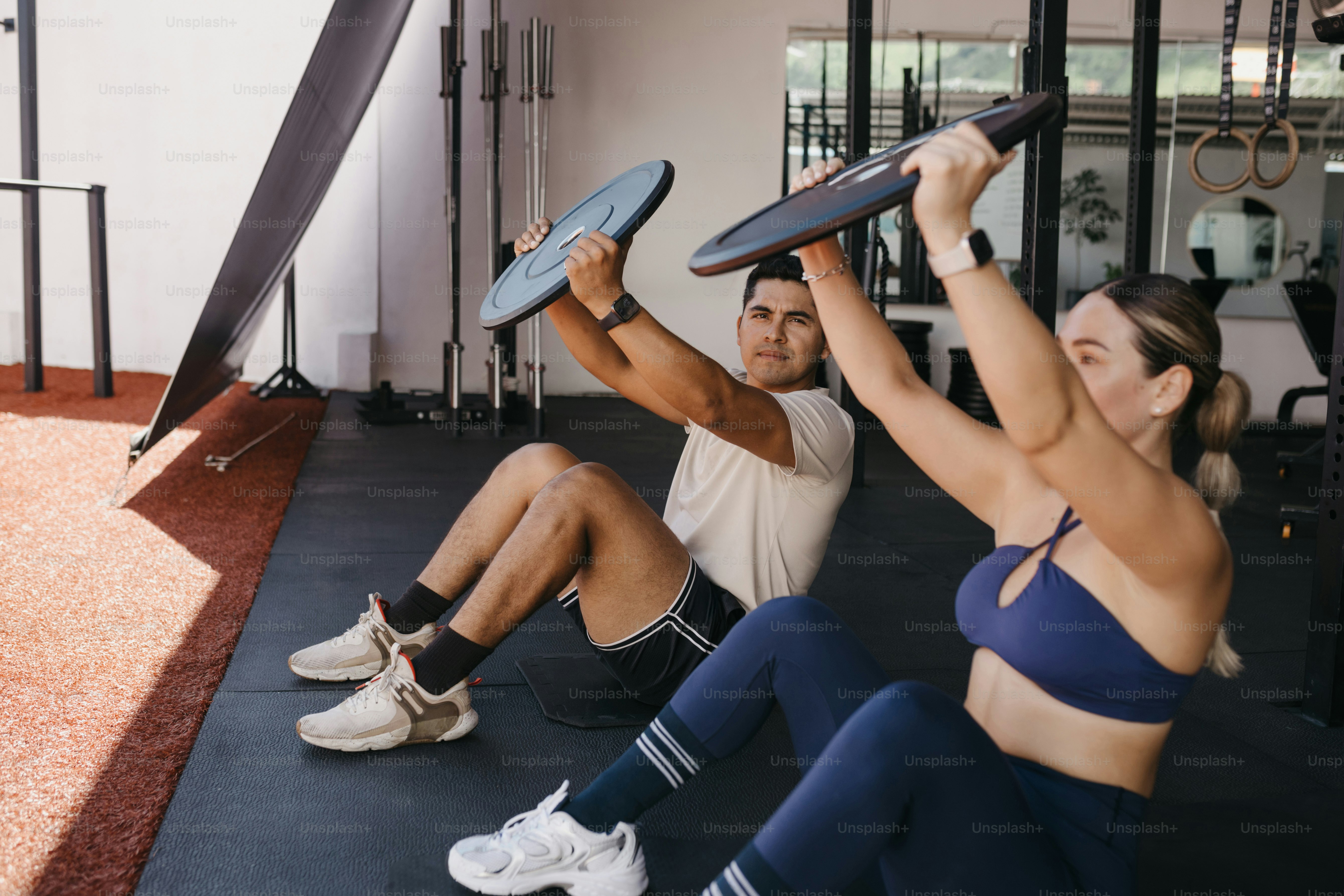 A group of people doing exercises in a gym photo – Personal training ...