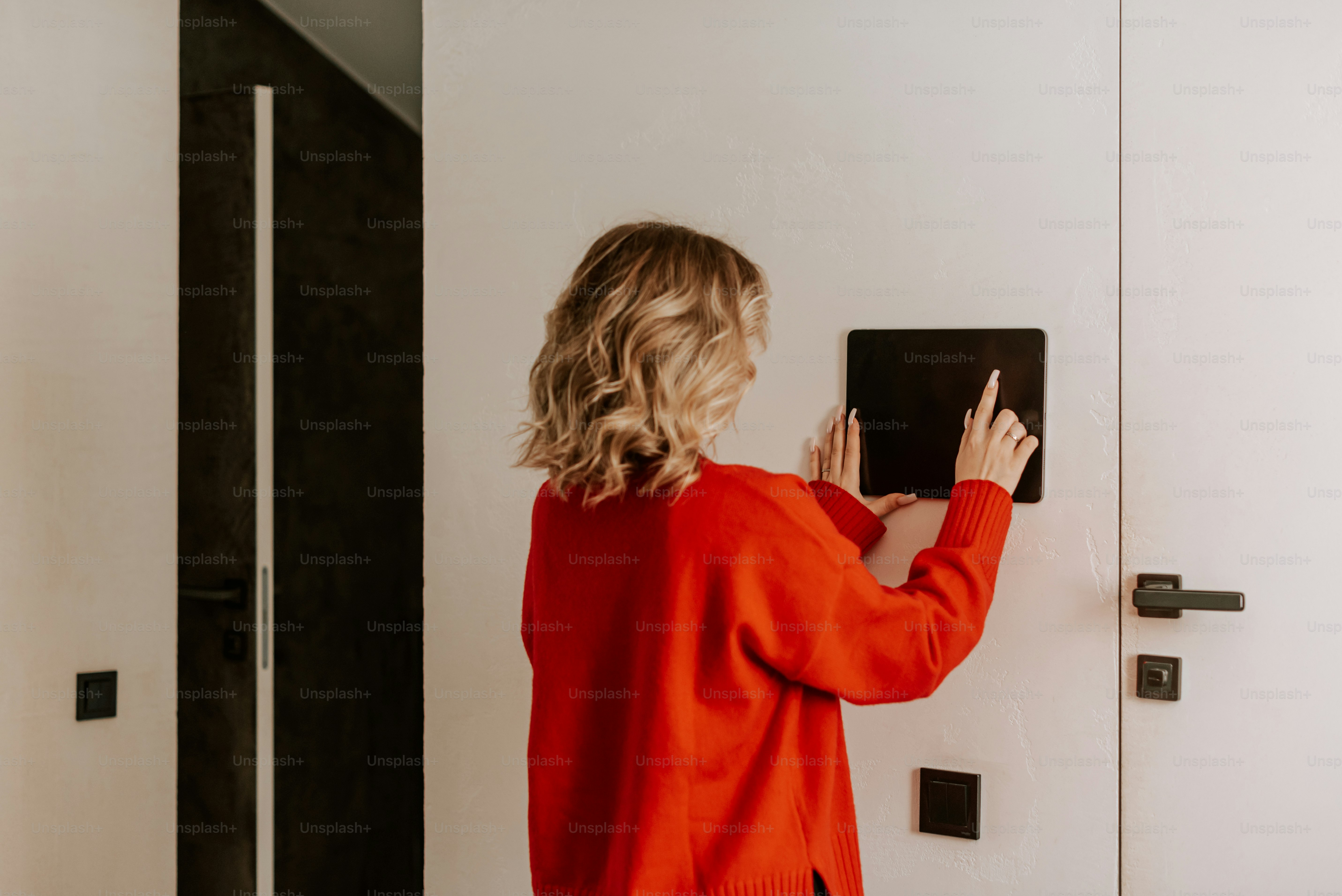 A woman standing in front of a white door