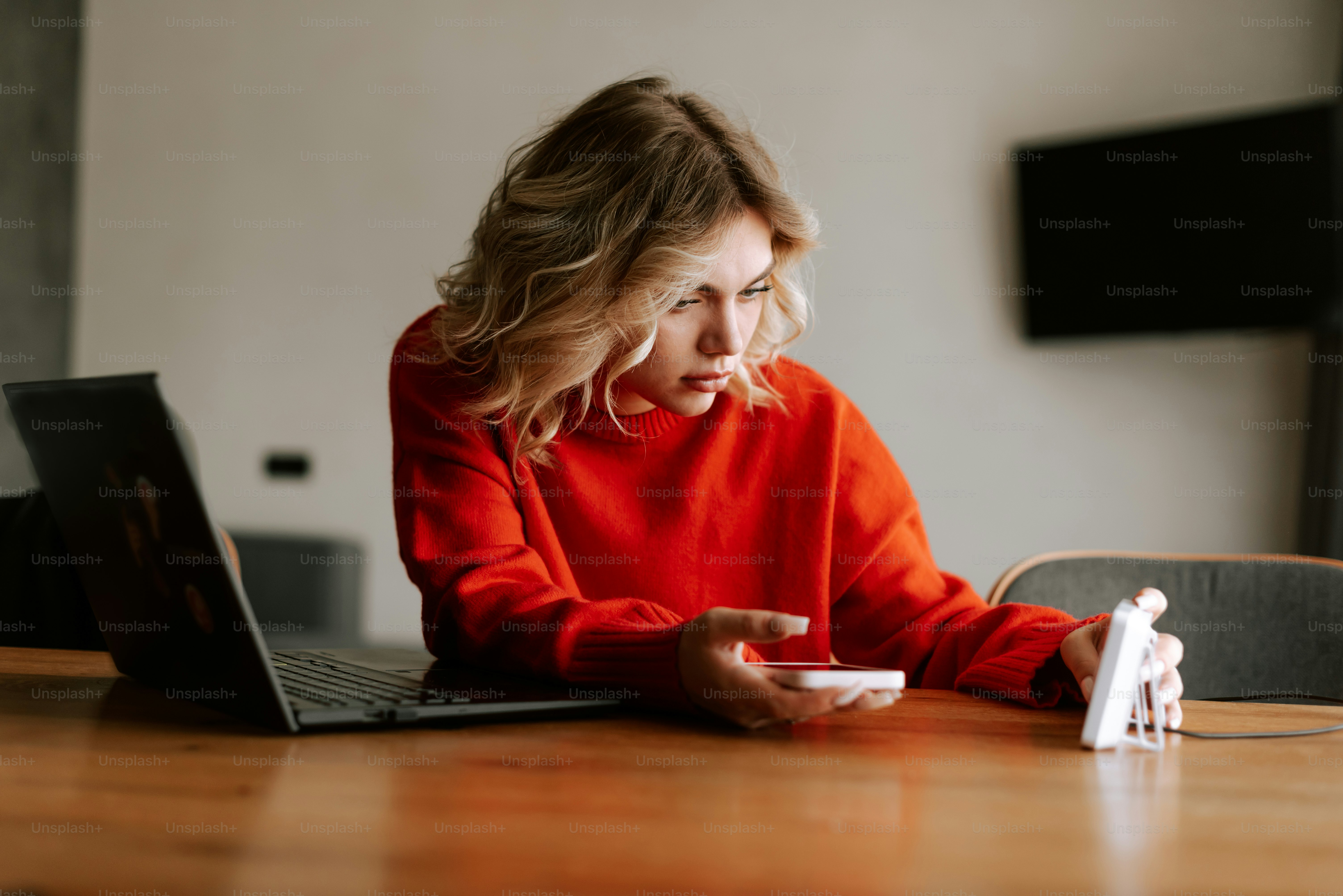 A woman sitting at a table using a laptop computer
