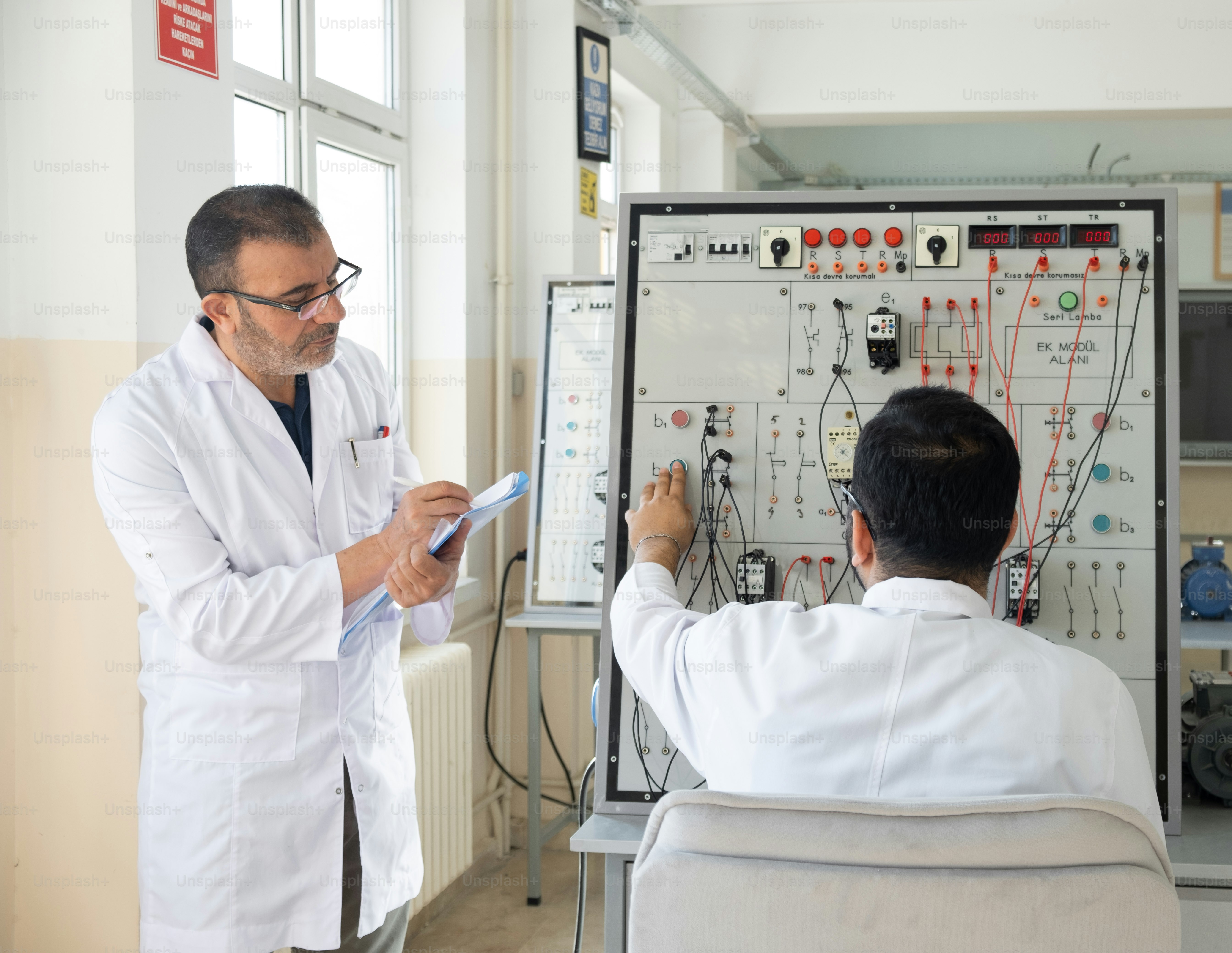 A man in a white lab coat and a man in a white lab coat are