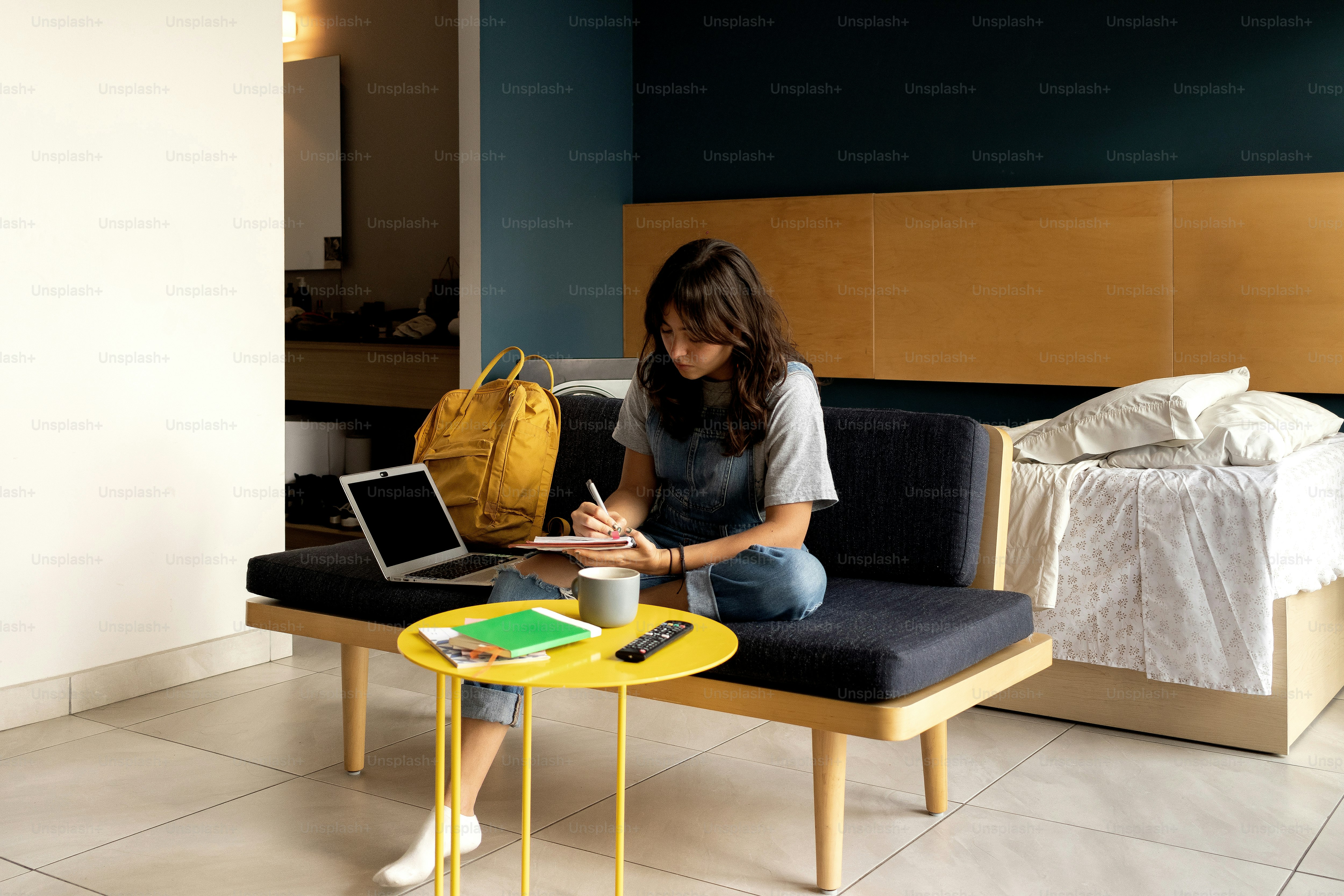 A woman sitting on a couch using a laptop computer