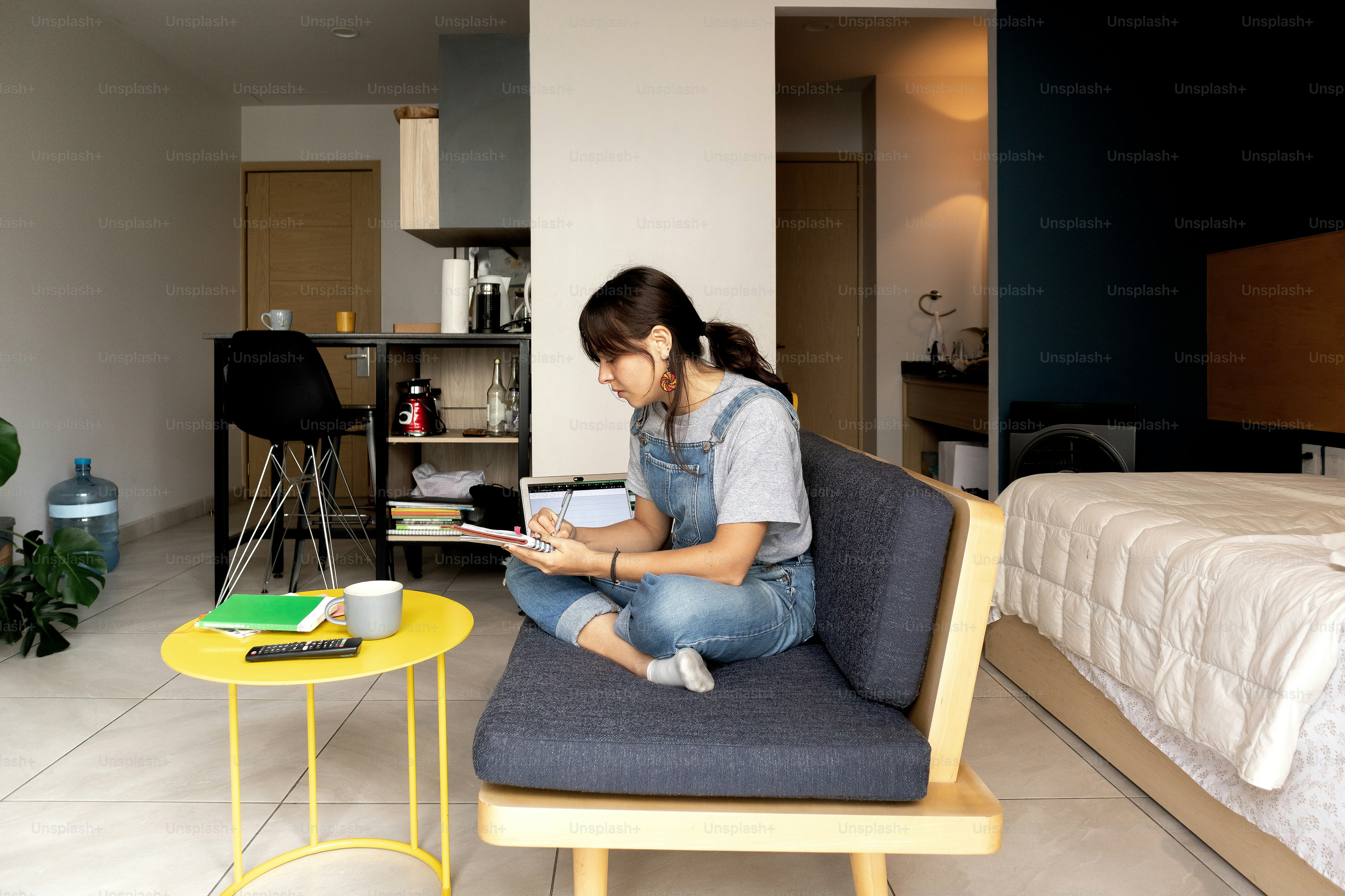 A woman sitting on a chair reading a book