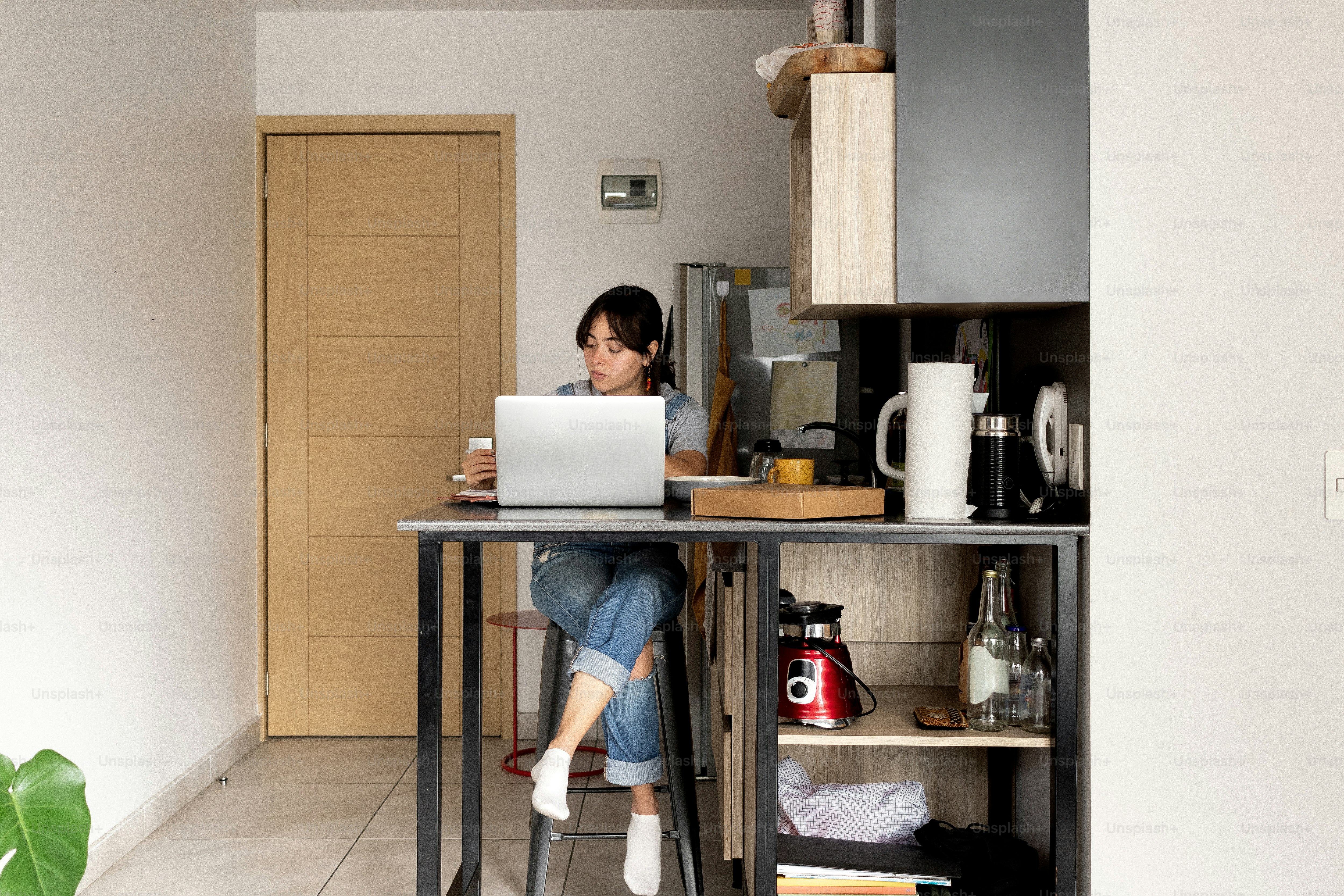 A person sitting at a table with a laptop