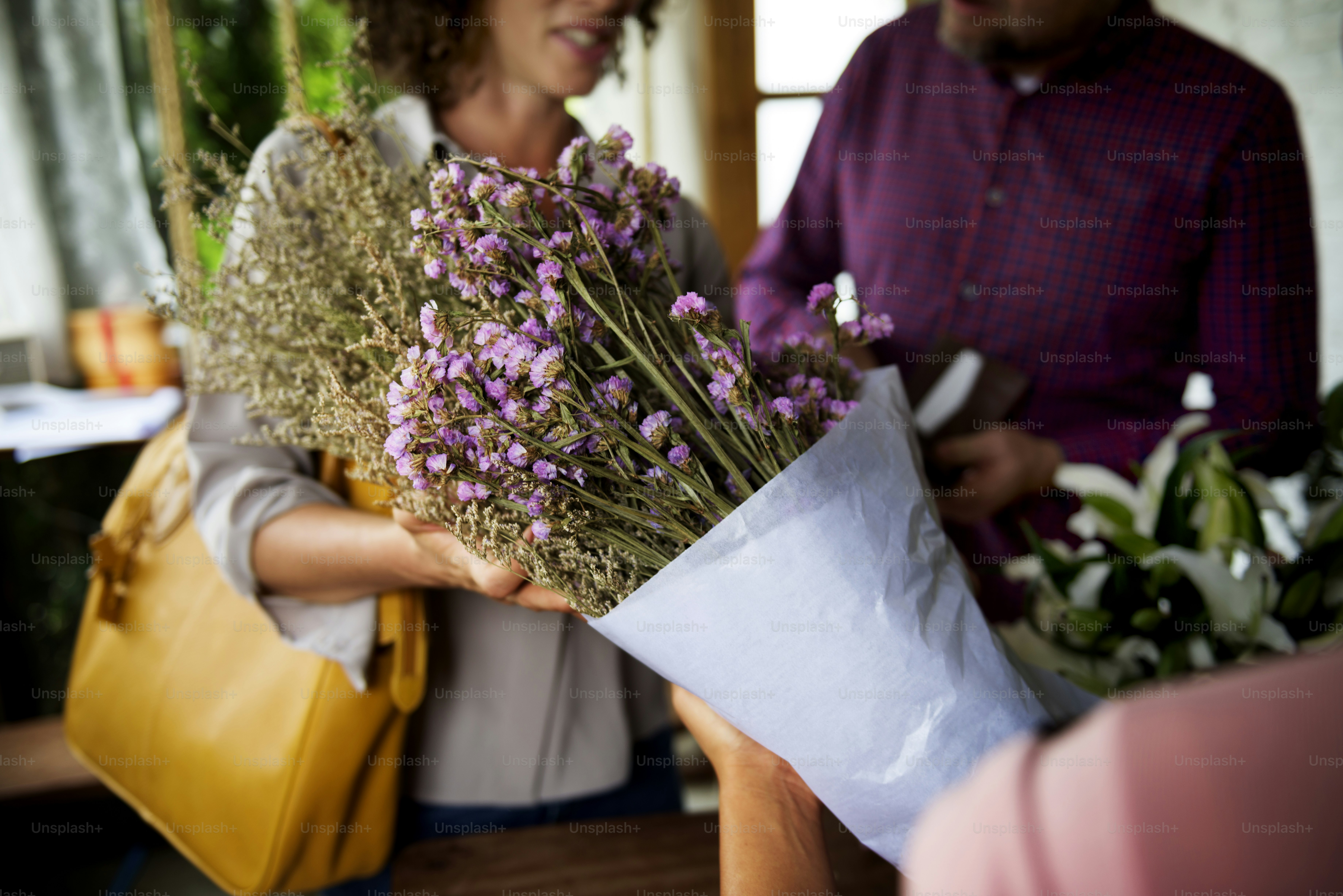 Local florist arranging seasonal flowers in a fresh bouquet
