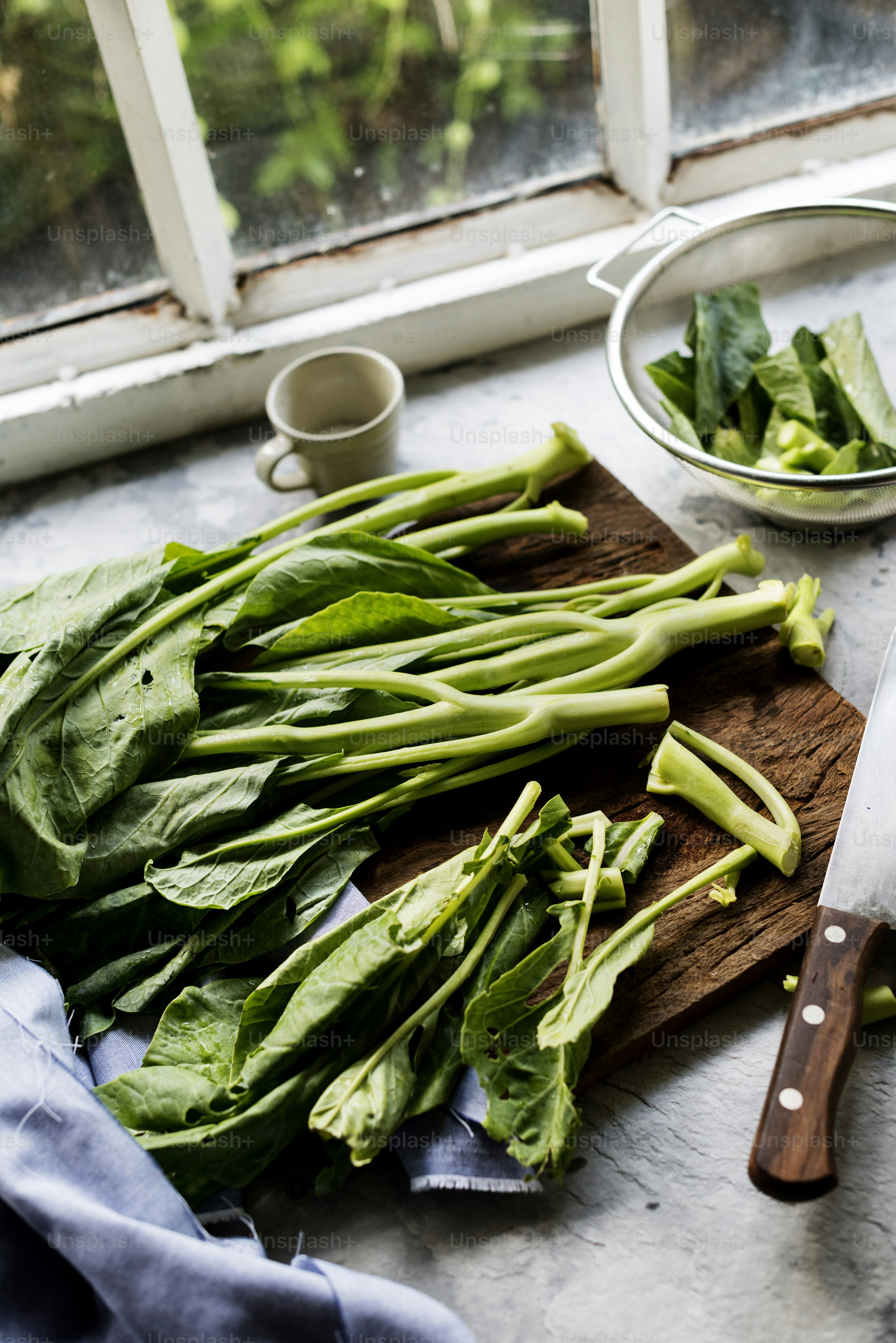 Aerial view of fresh collard chinese kale on wooden cutboard photo ...