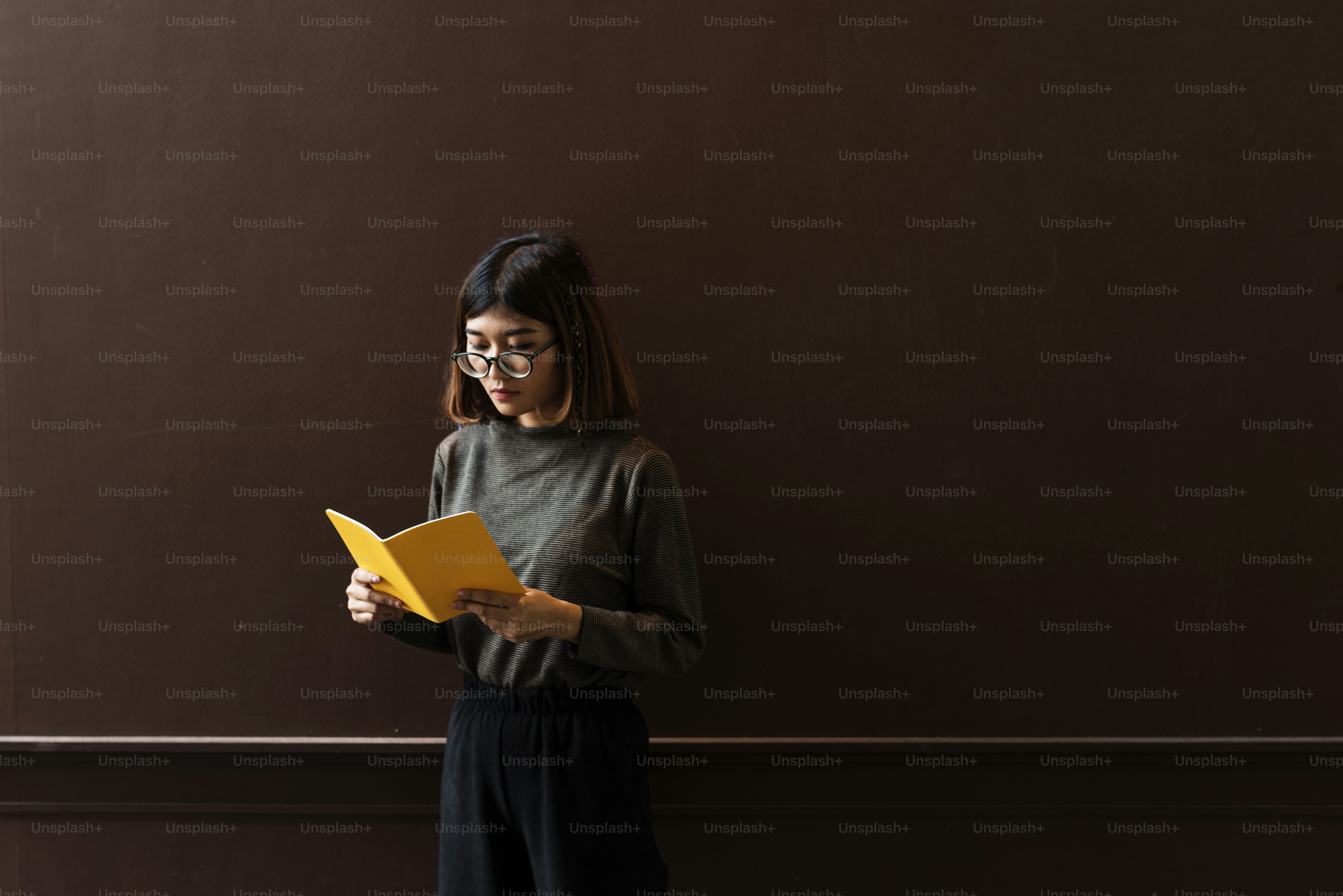 Girl with Glasses Standing Reading Book